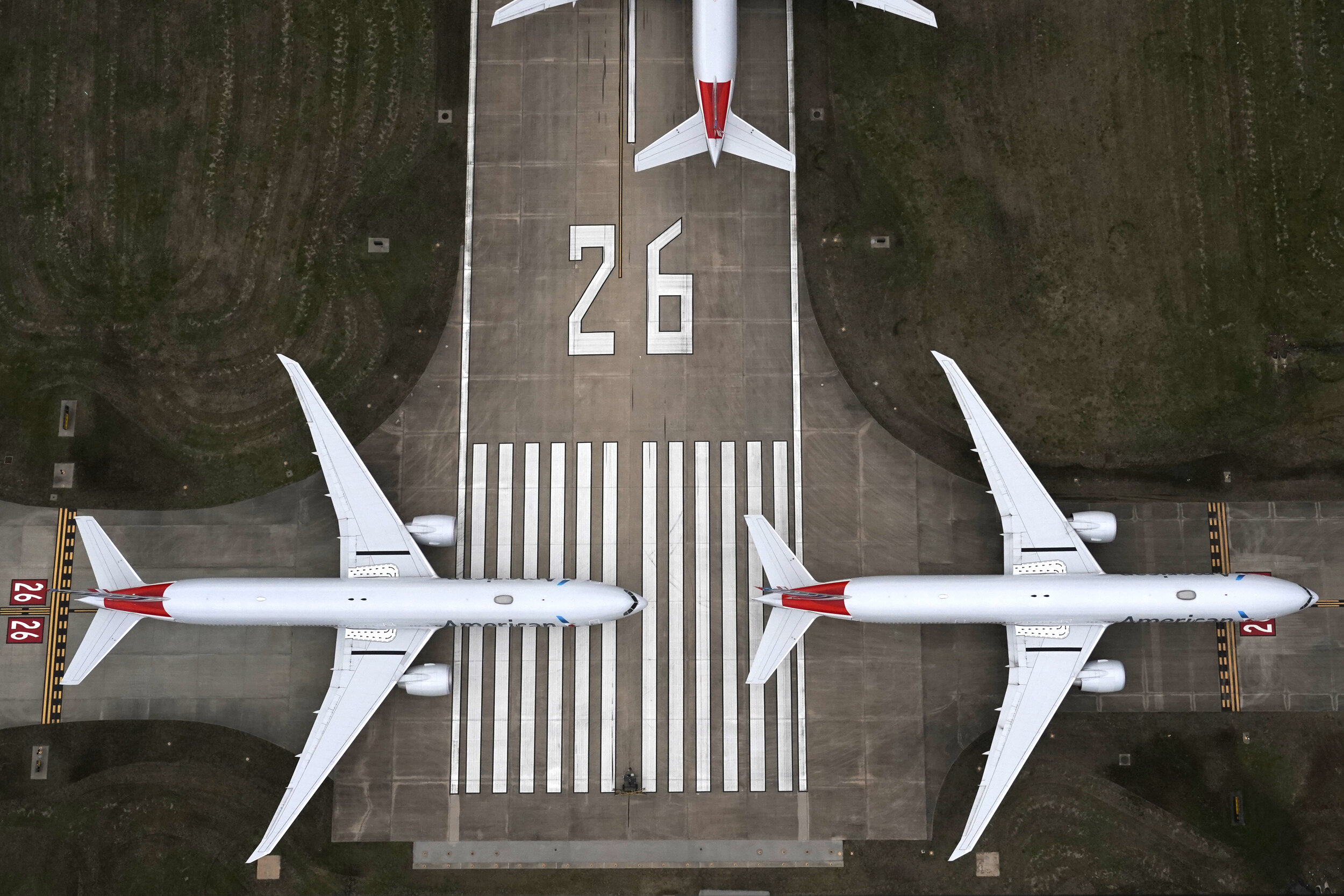  American Airlines passenger planes crowd a runway where they are parked due to flight reductions made to slow the spread of coronavirus disease (COVID-19), at Tulsa International Airport in Tulsa, Oklahoma, U.S. March 23, 2020. REUTERS/Nick Oxford 