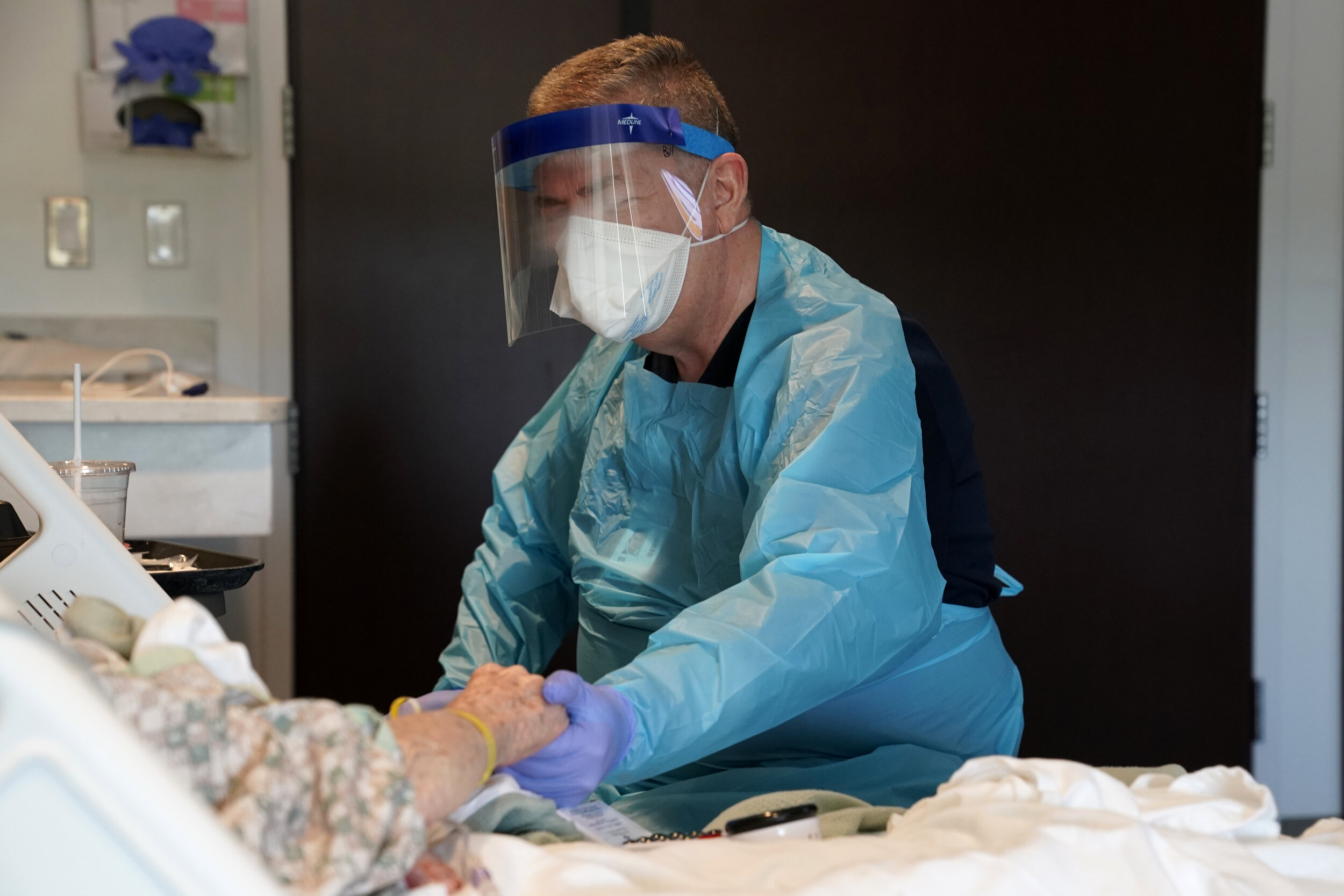  Board Certified Chaplain Bill Simpson prays with a patient under investigation for coronavirus at SSM Health St. Anthony Hospital amid the spread of the coronavirus disease (COVID-19), in Shawnee, Oklahoma, U.S. April 23, 2020. REUTERS/Nick Oxford 