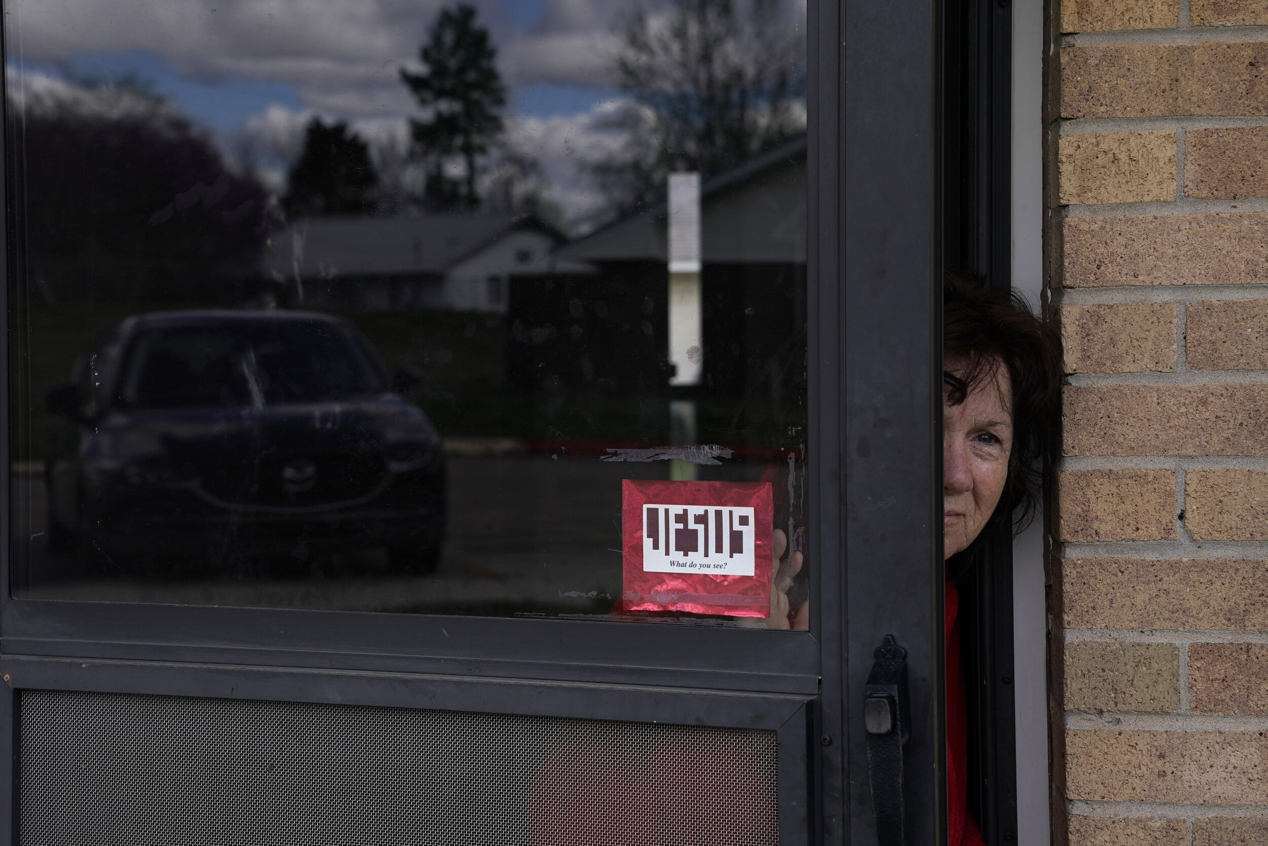  Patricia Flood, who has COPD and other health issues, peeks out of her front door in Bristow, Oklahoma, March 24, 2020. Nick Oxford for The Washington Post 