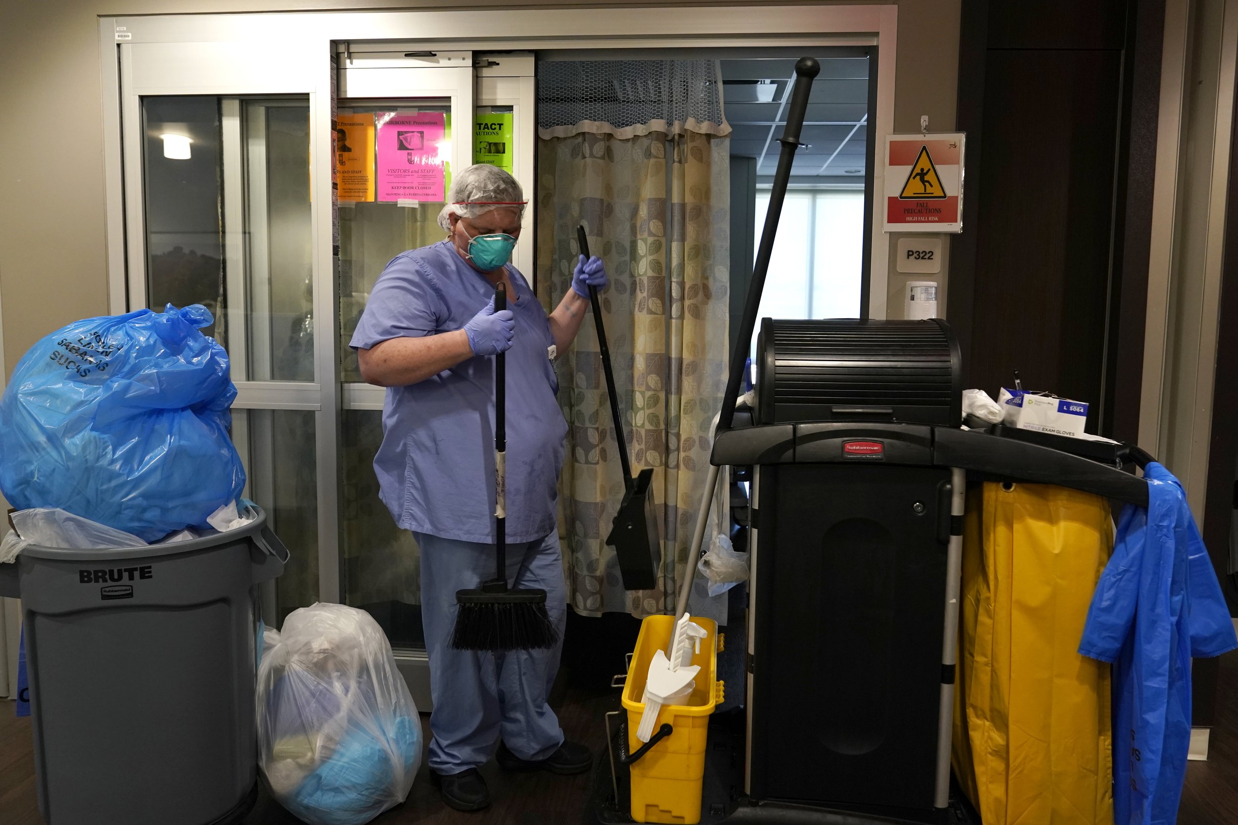  A member of the Environmental Services team disposes of linens after cleaning a COVID-19 patients room during a tour of SSM Health St. Anthony Hospital's intensive care unit (ICU) amid the coronavirus disease (COVID-19) pandemic in Oklahoma City, Ok