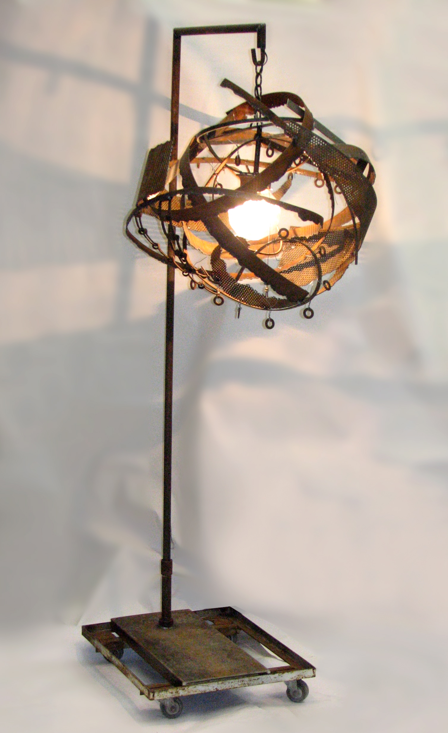 Standing Light Sculpture , welded steel with light component on antique dolly, 86"h x 30"w x42"d