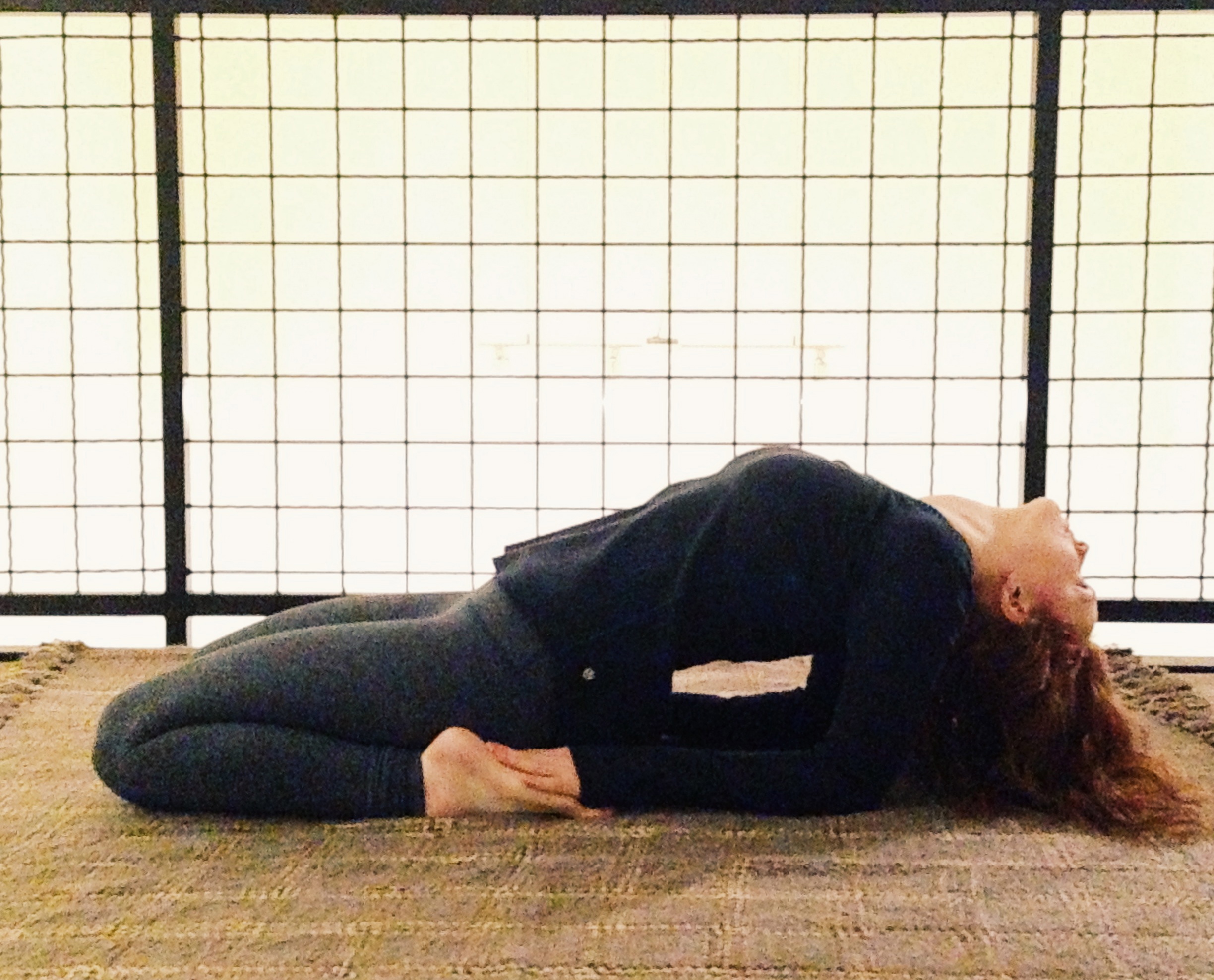 Leah in a variation Hero Pose stimulating proper function of the thyroid and digestive system, stretching the abdomen, hip flexors, knees, ankles and feet. Easy modifications make this posture available during class for all to benefit.