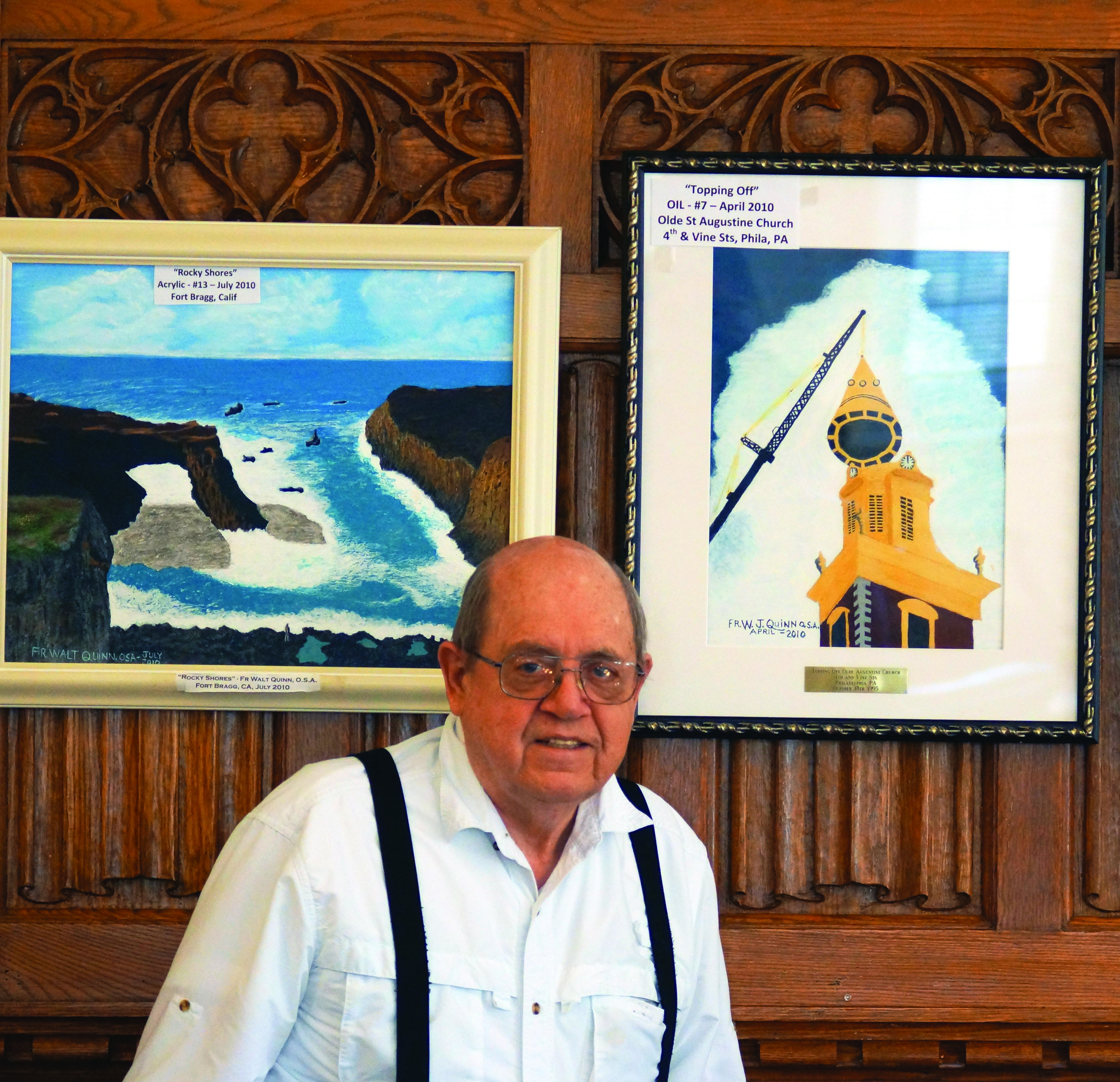 Father Walter J. Quinn, O.S.A., stands in front of some of the art featured in the exhibit.