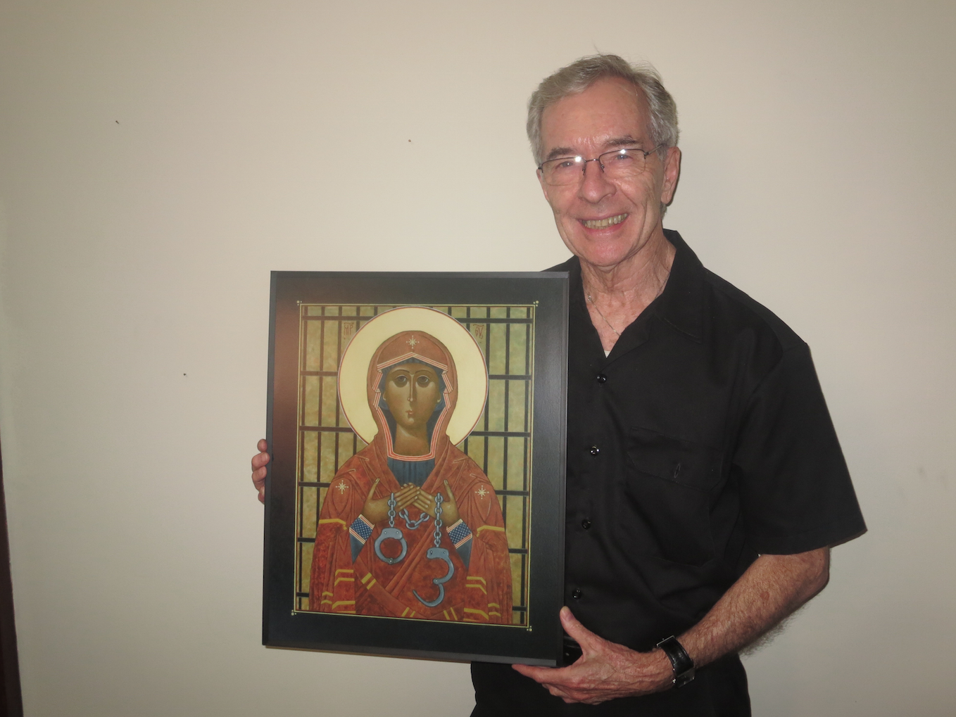 Father Paul Morrissey, O.S.A., holding the icon, "Mary, Mother of Captives."