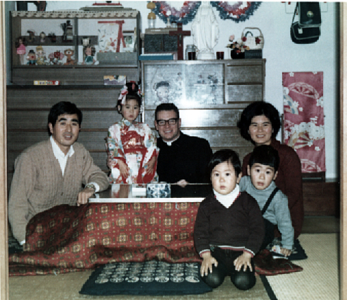 Father Tom Dwyer with a family from the Nagasaki community.