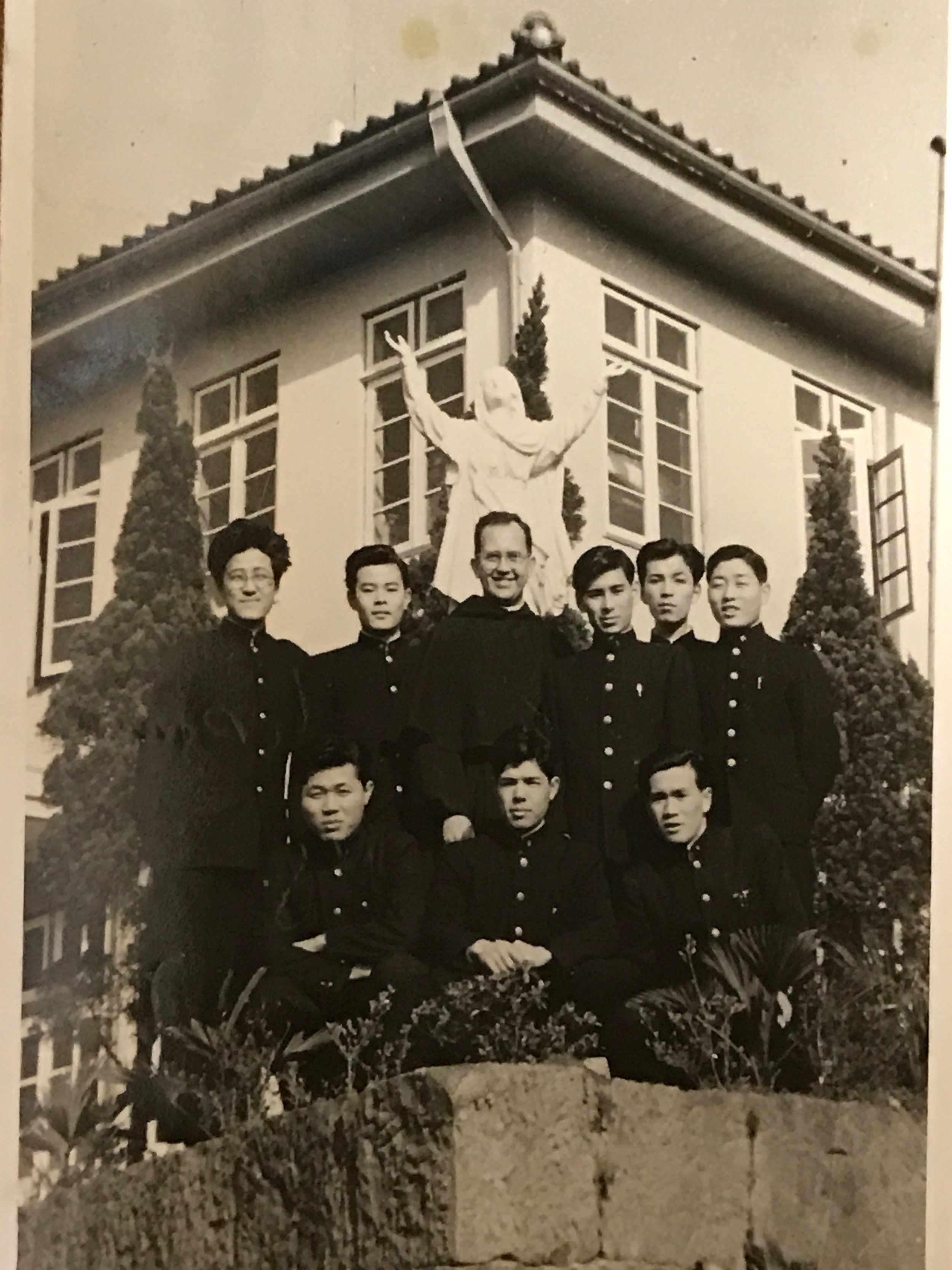 Father Krupa in front of the Hostel on the Nagasaki property that housed college students.