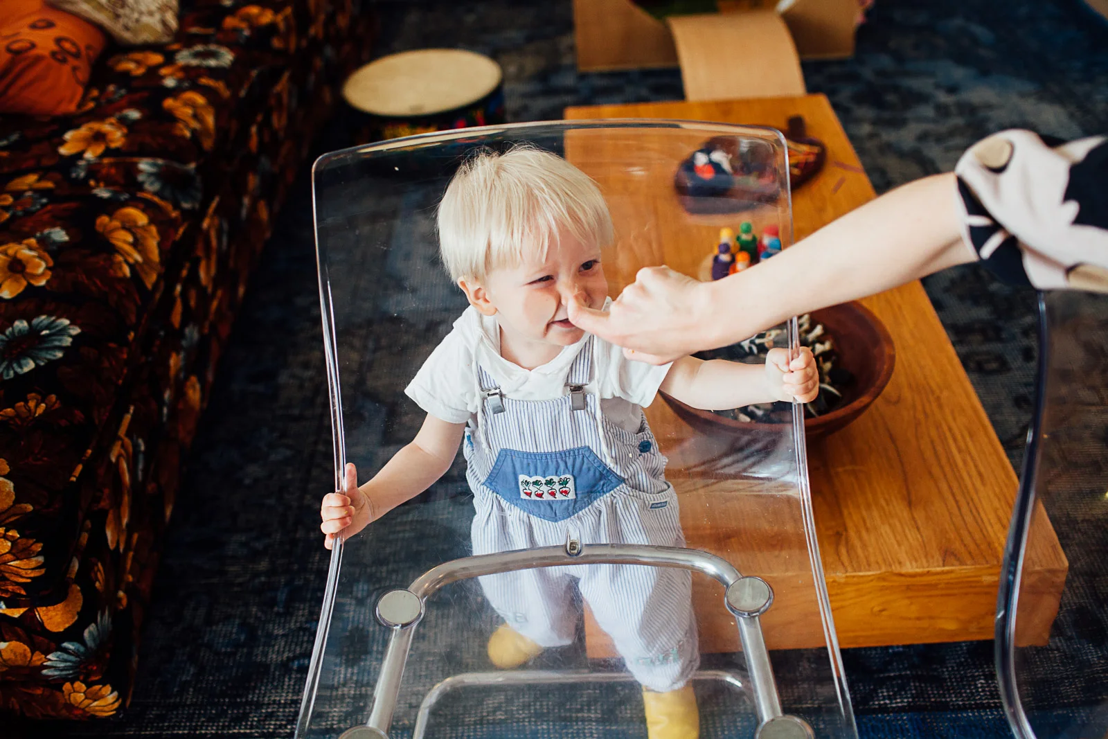 toddler faces through a transparent chair