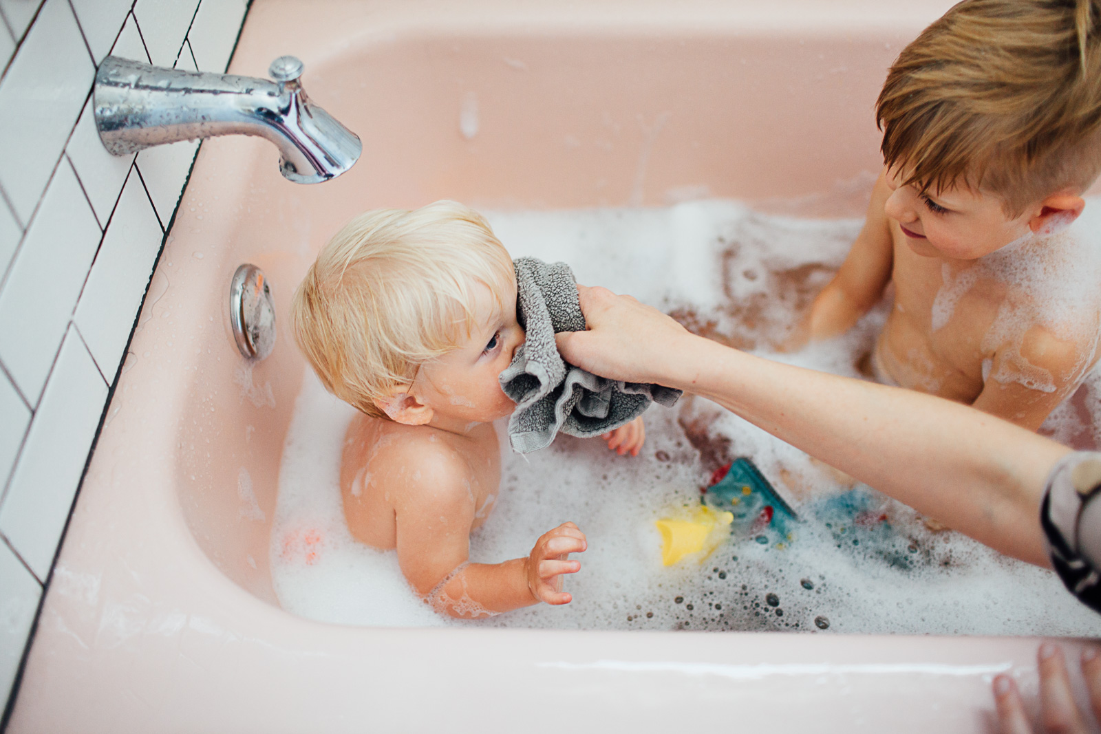 brothers in a pink bath tub by Maryland Documentary photographer Juliette Fradin