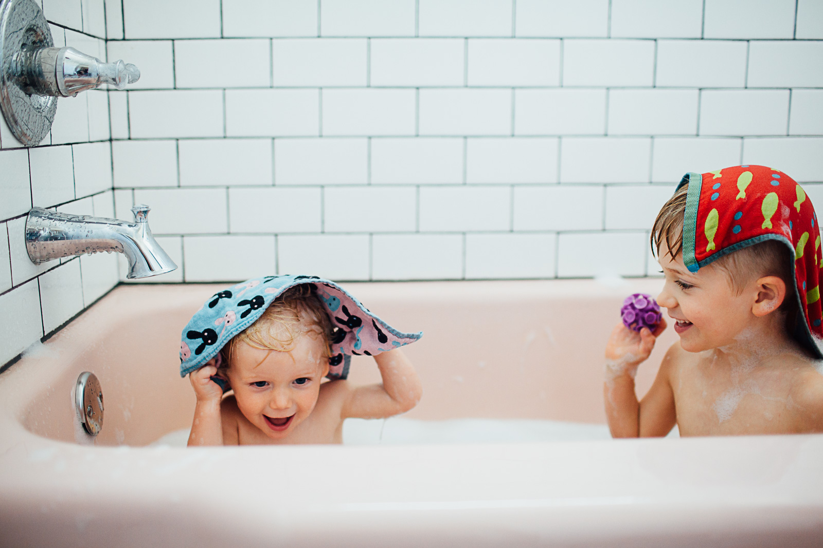 brothers in a pink bath tub by Maryland Documentary photographer Juliette Fradin