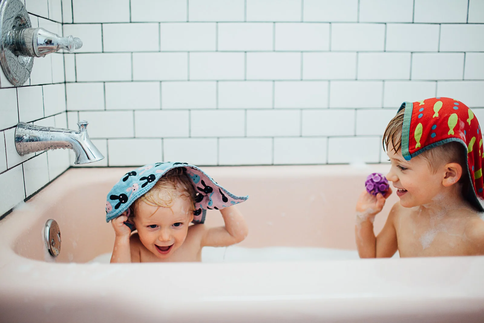 brothers in a pink bath tub by Maryland Documentary photographer Juliette Fradin