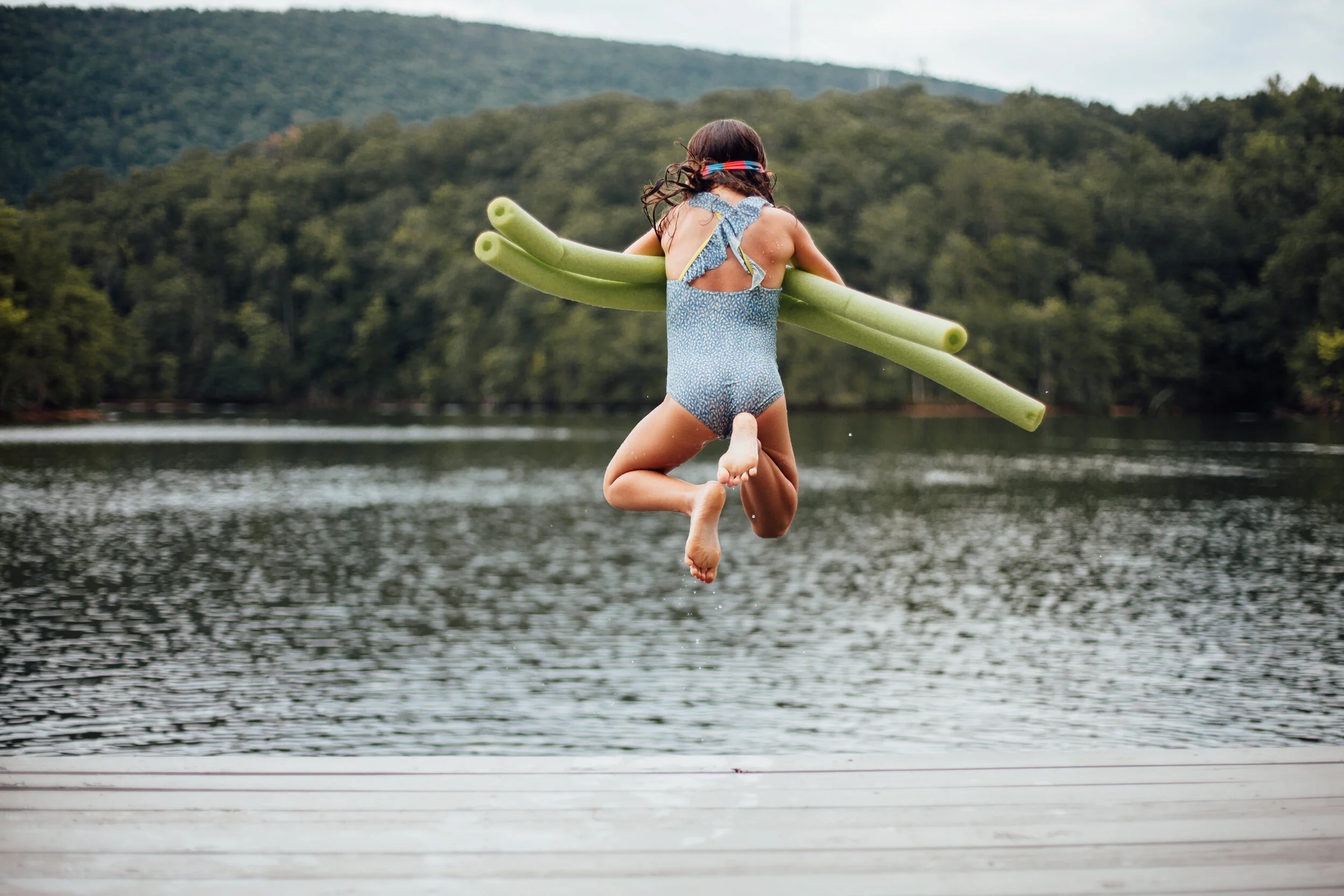 girl jumping in the lake from dock.jpg