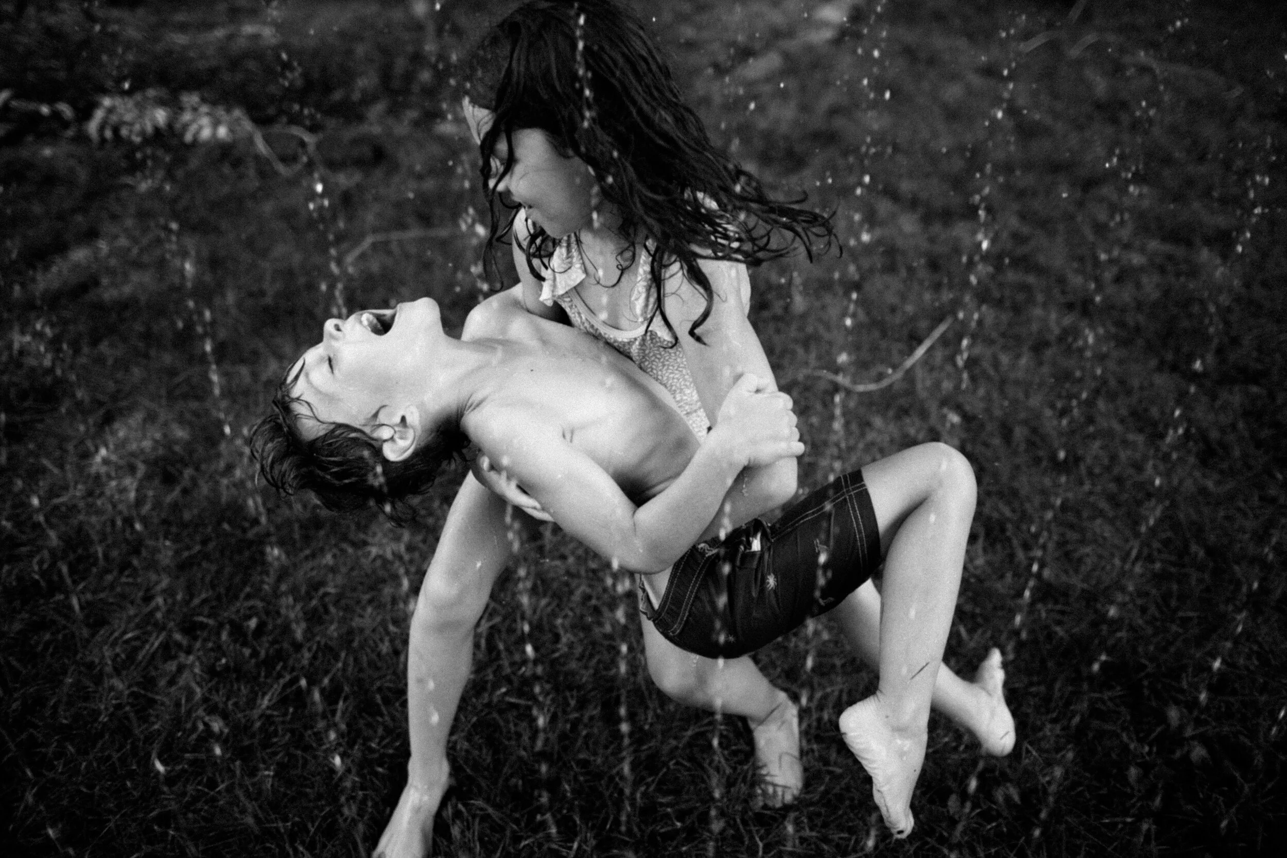 kids dancing in water sprinkler.jpg
