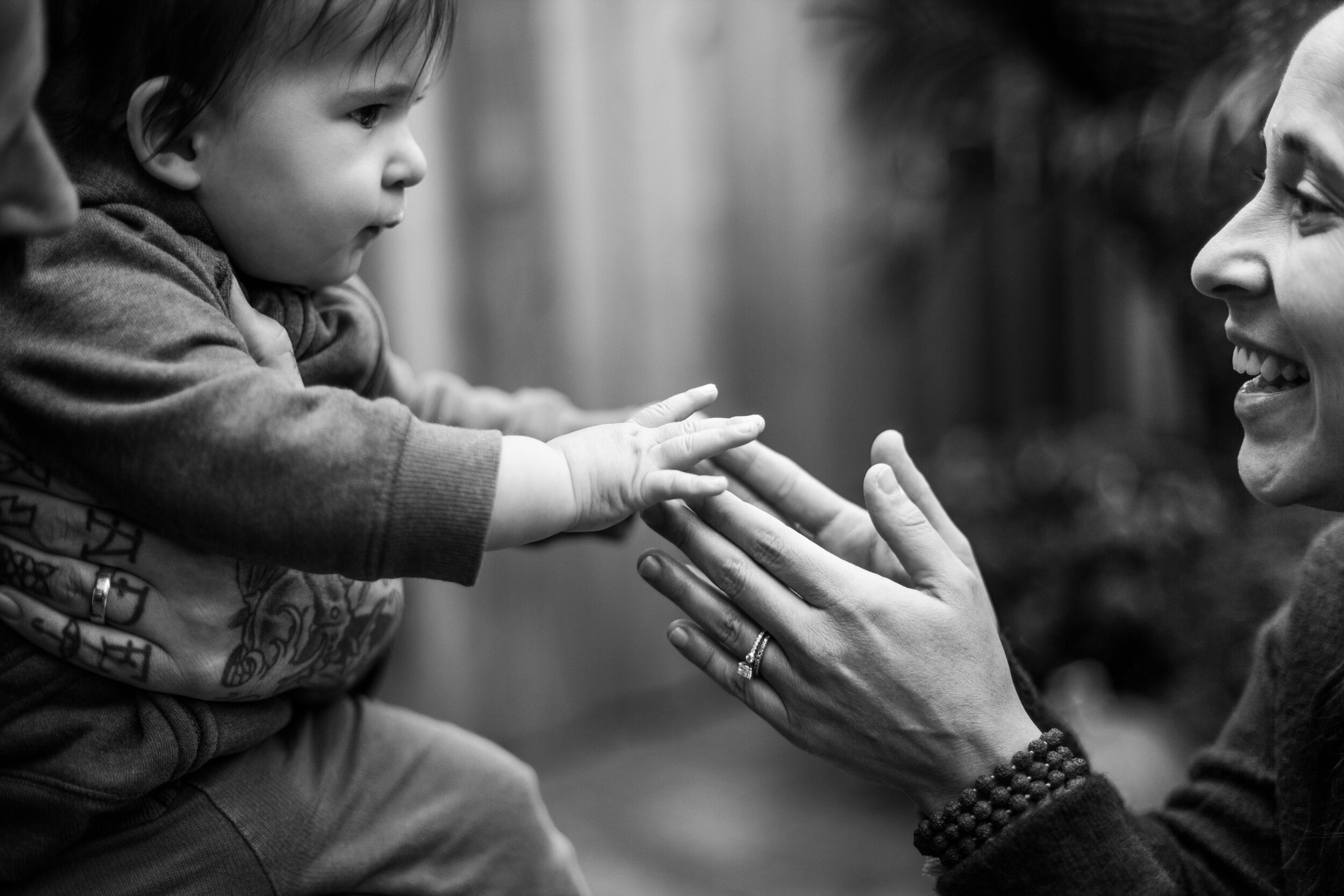 mom and son's hands touching in black and white.jpg