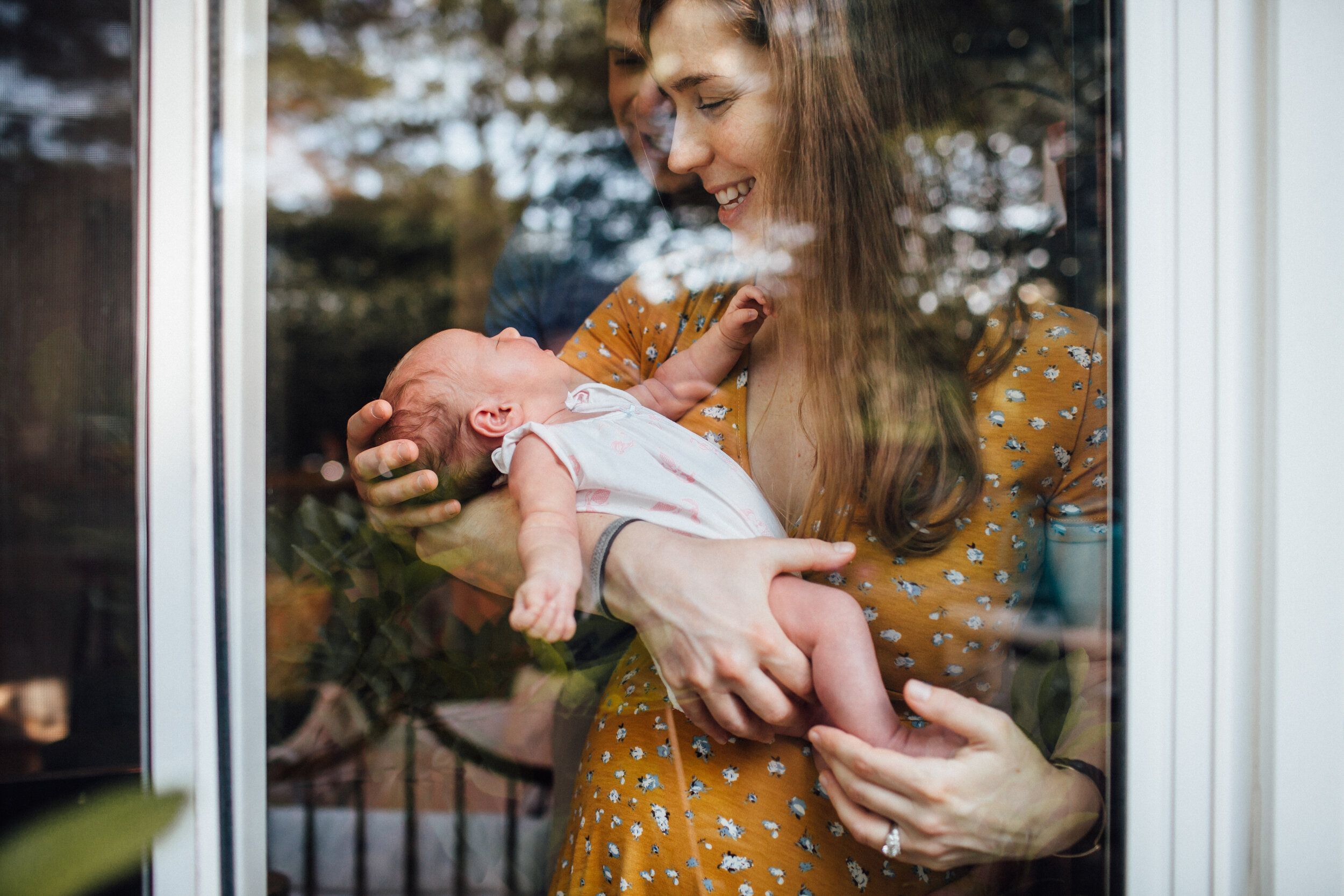 newborn baby through a window.jpg