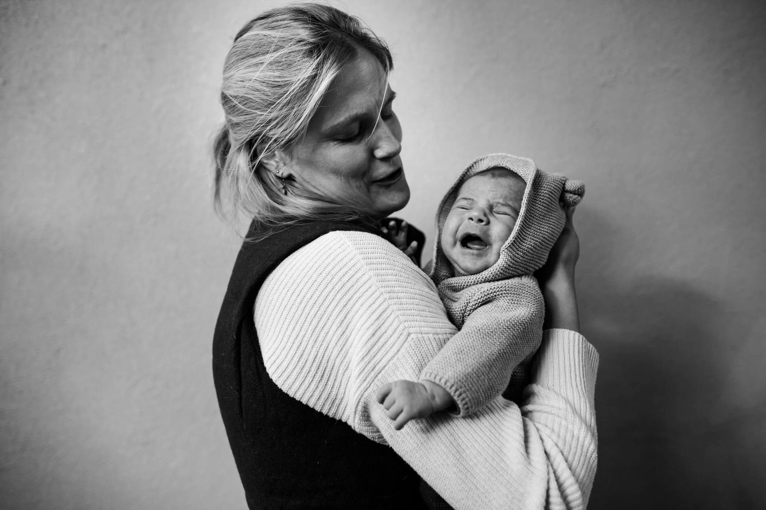 newborn crying in his mom's arms.jpg
