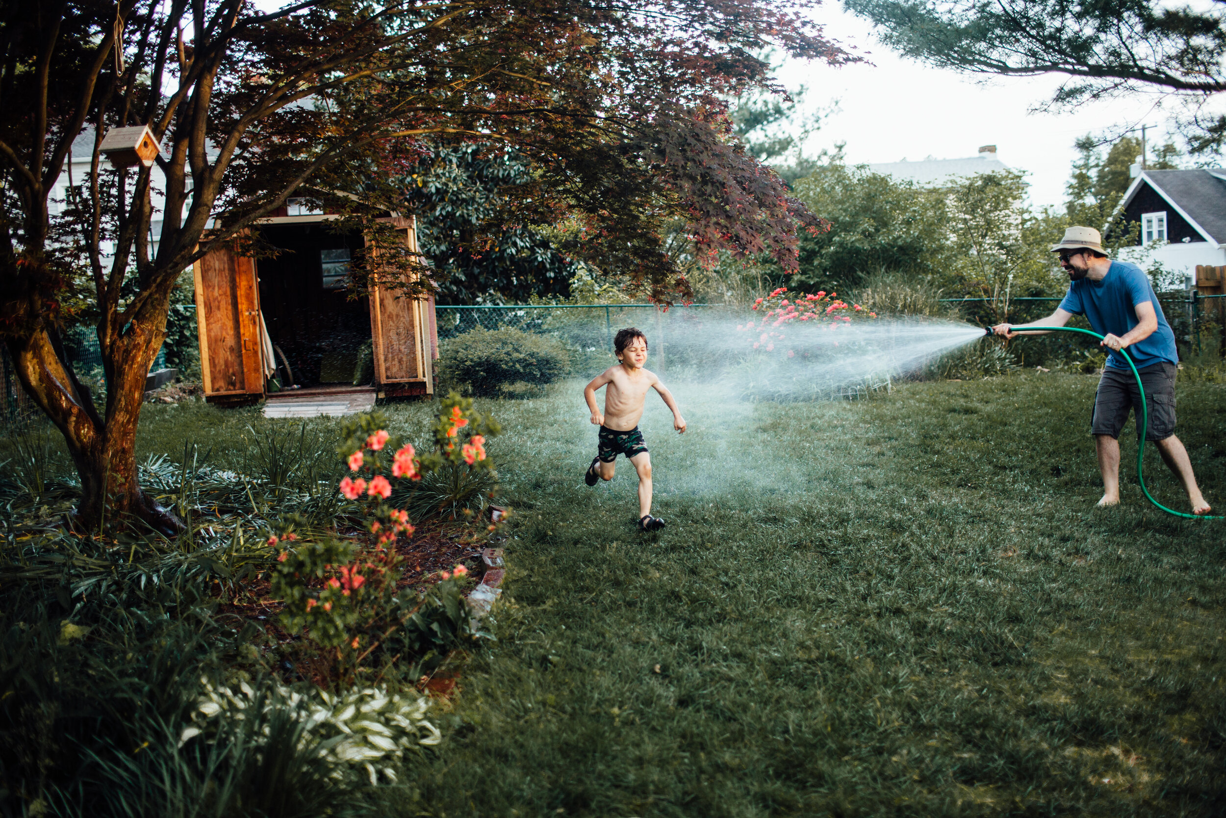 boy runiing in water sprinkler.jpg