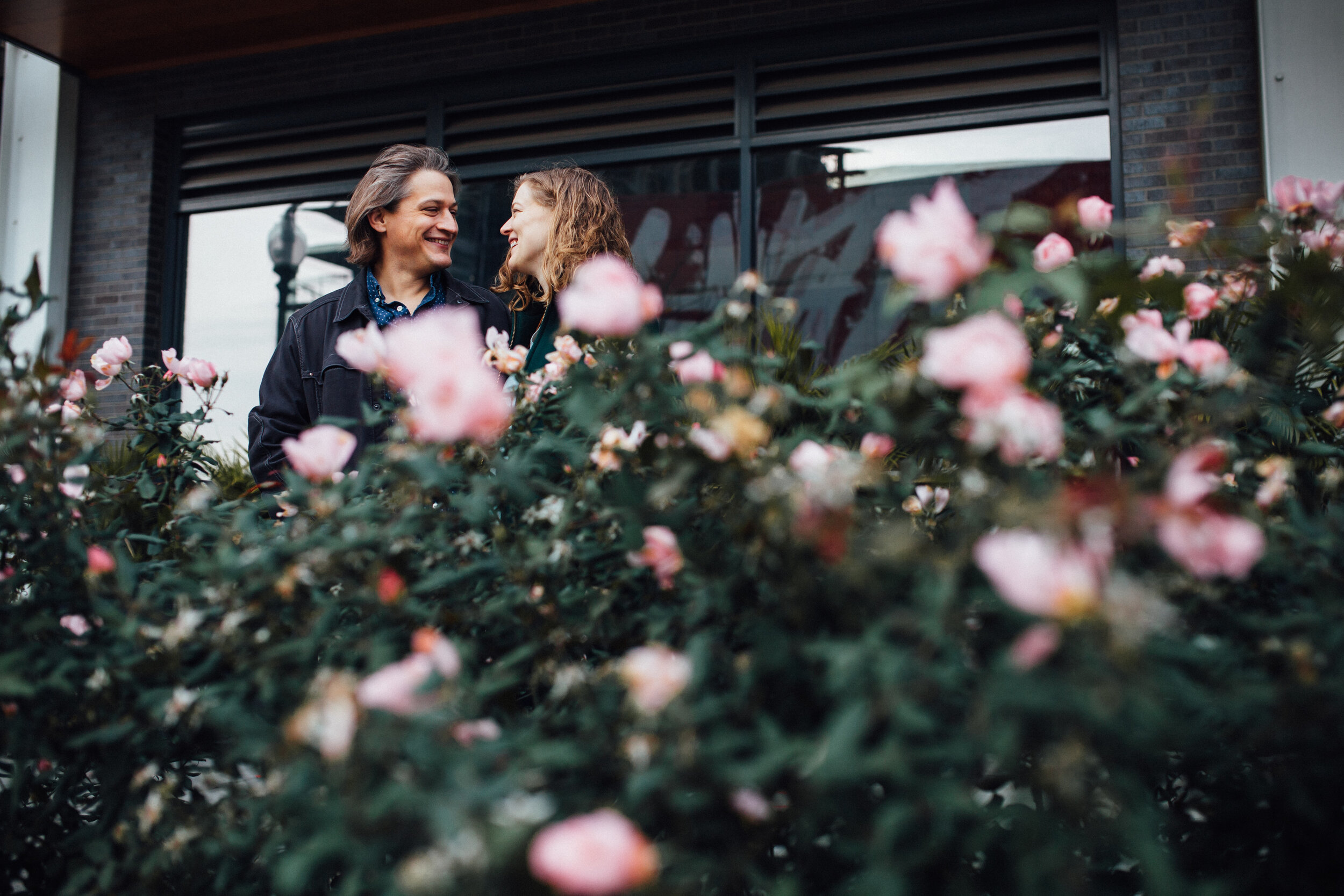 couple behind a bush of roses.jpg