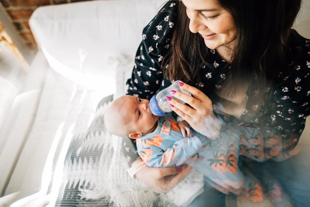 mom bottle-feeding her newborn
