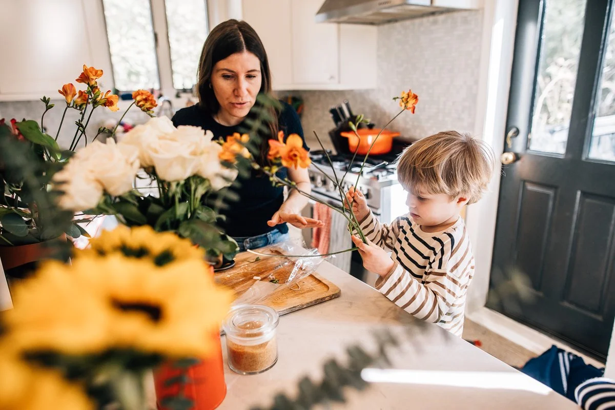 mom and son arranging flowers in the kitchen
