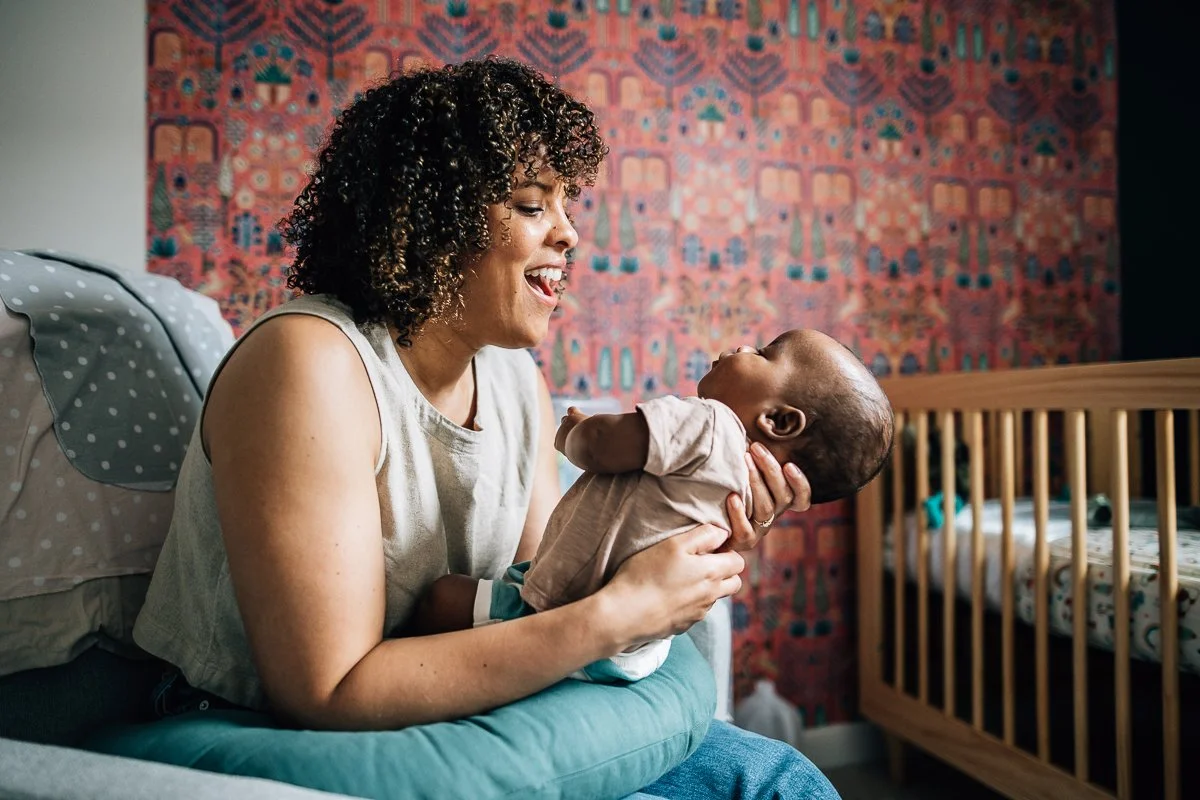 mom smiling at her newborn son