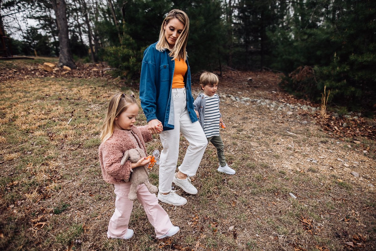 mother holding son and daughter's hands for a walk