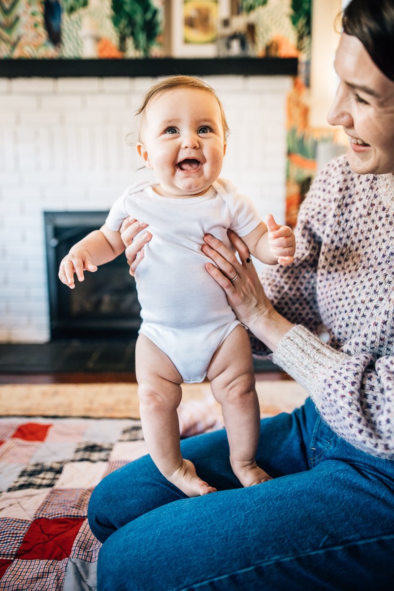 smiling baby on mother's lap