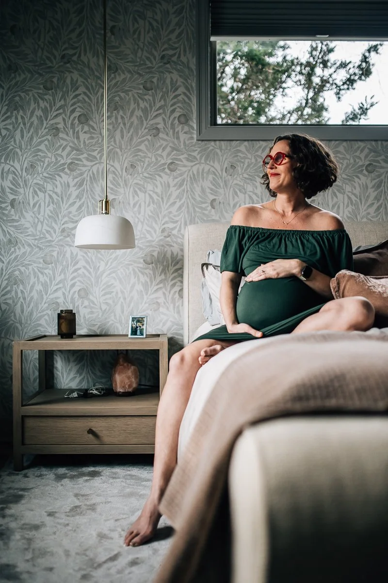 pregnant woman on bed looking towards the left