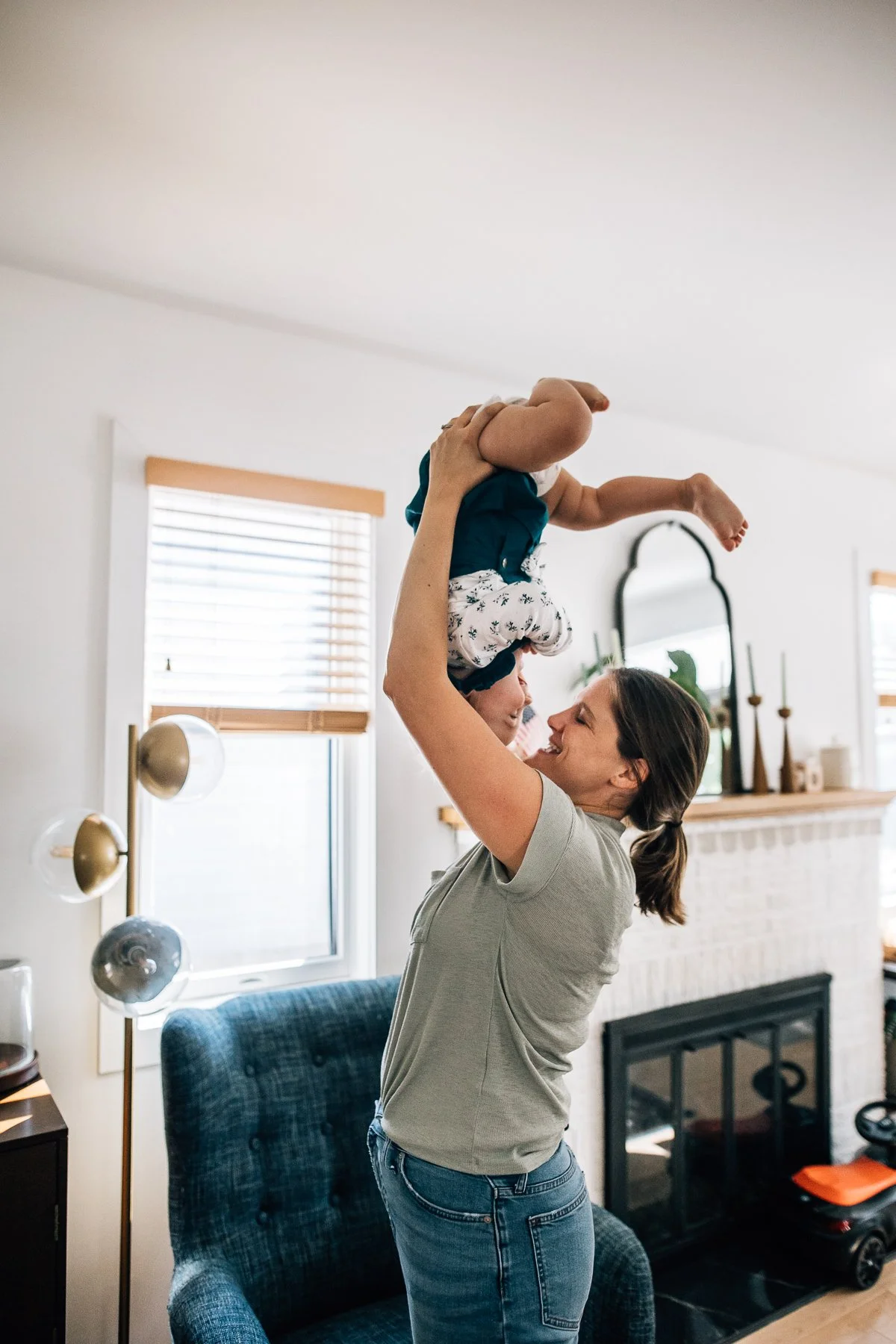 mom holding her daughter upside down