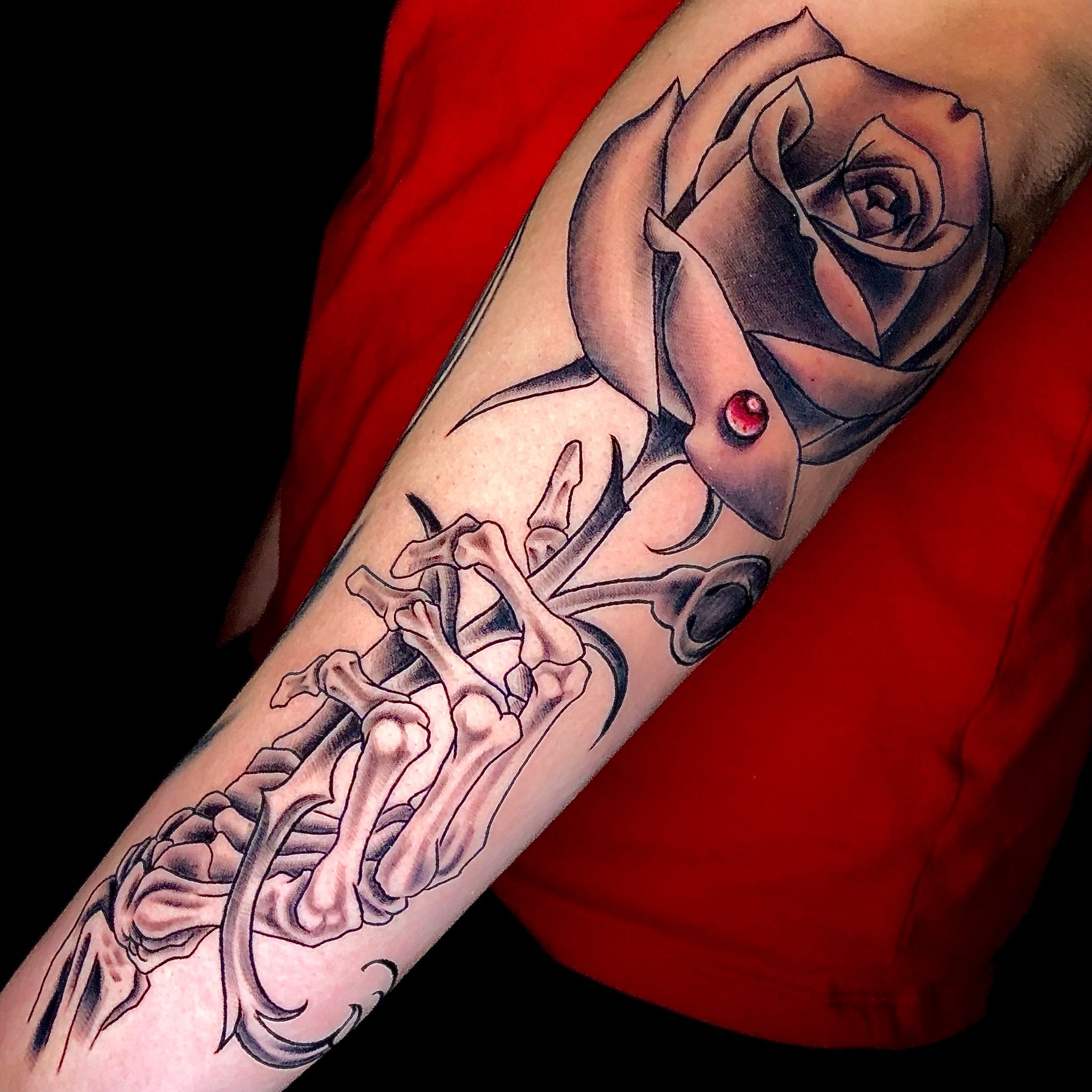 skeleton hand holding rose