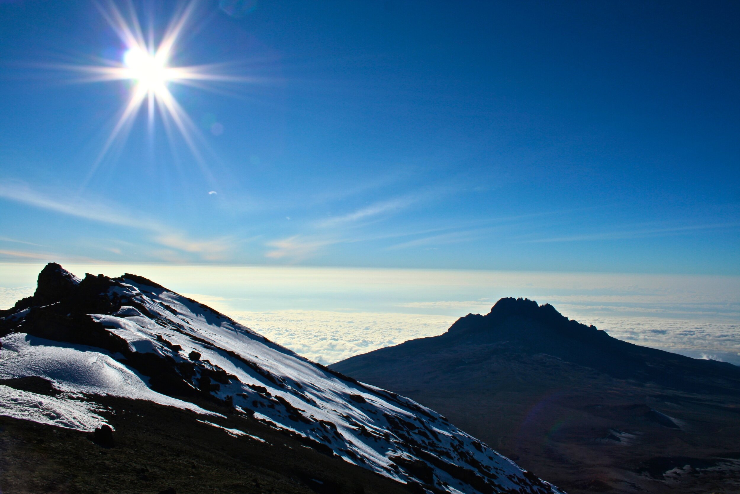 The summit rim of Kilimanjaro with Mount Mawenzi in the background.jpg