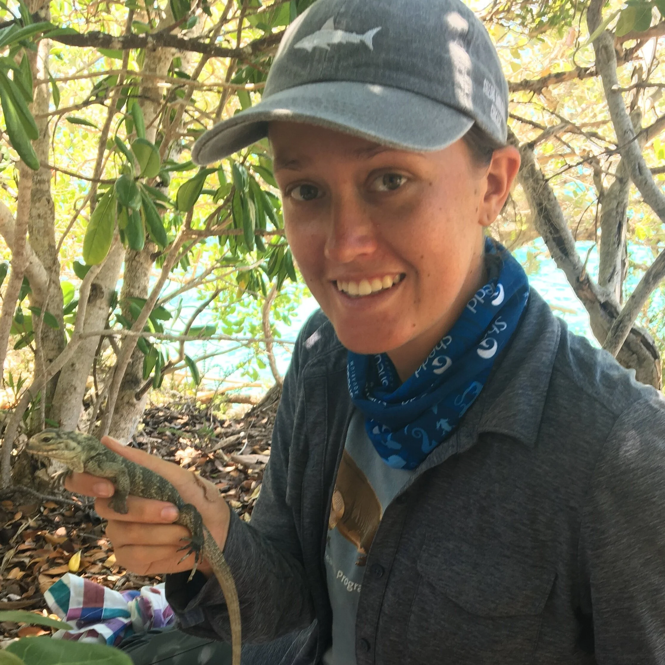 Erin holding a iizard in a mangrove forest