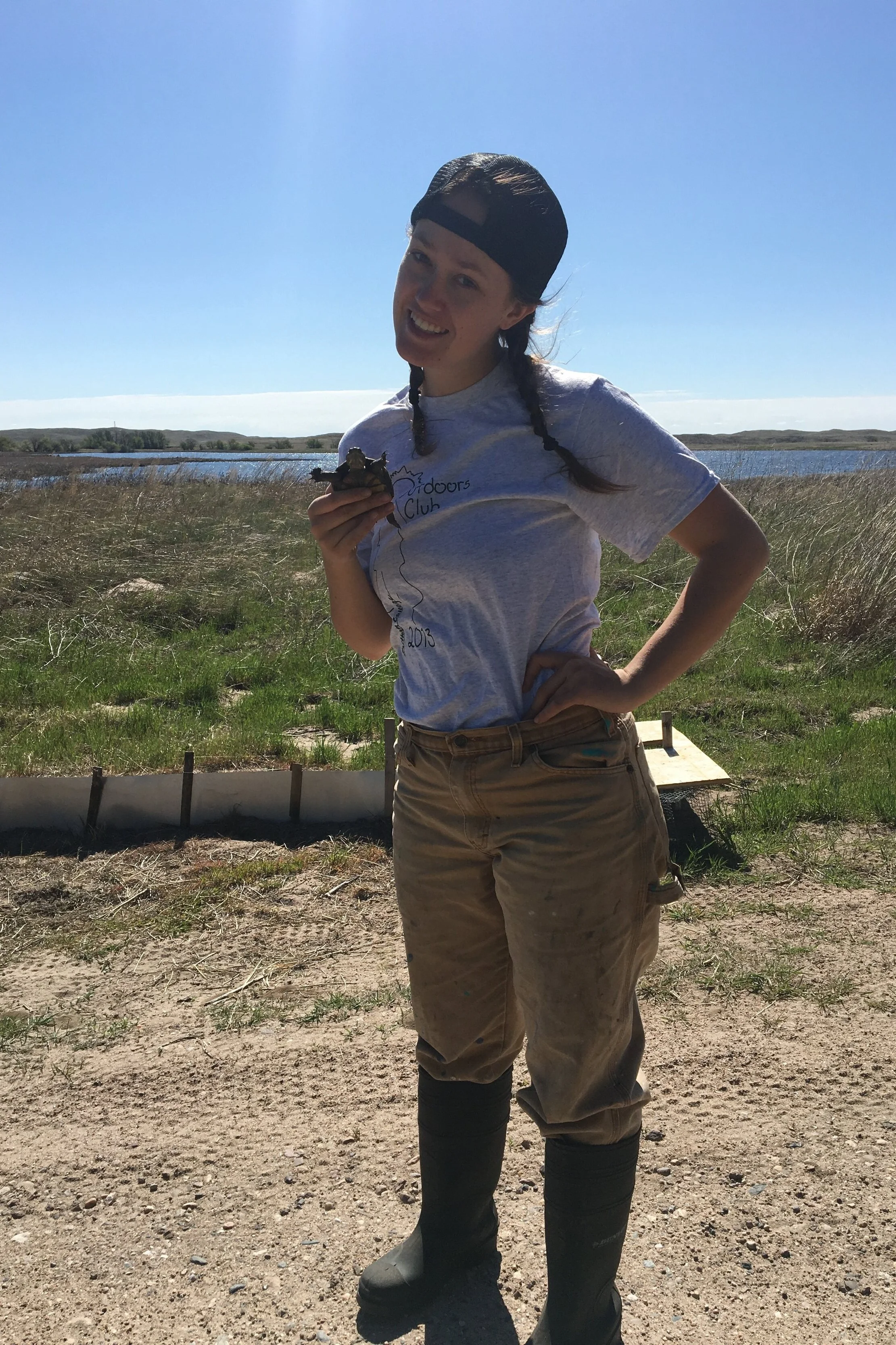 Erin holding a baby mud turtle at a Nebraska nesting site
