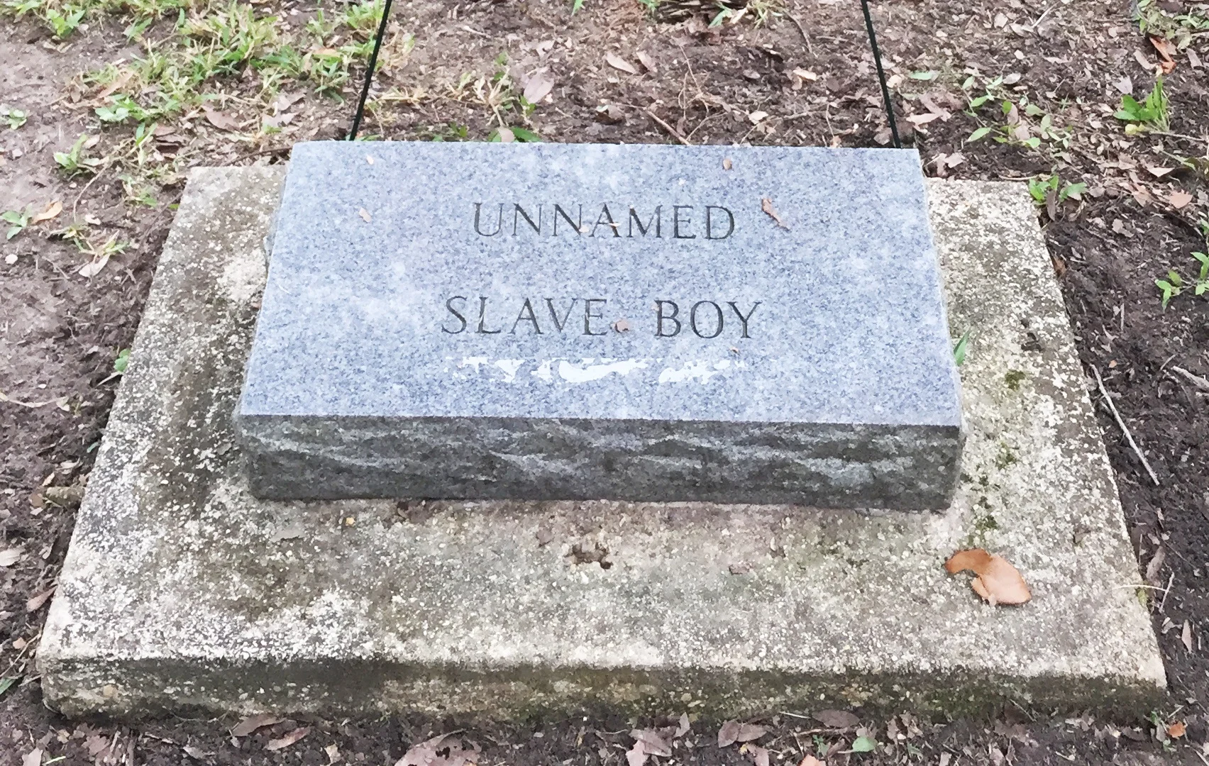 The headstone for gaston currently reads: "unnamed slave boy"