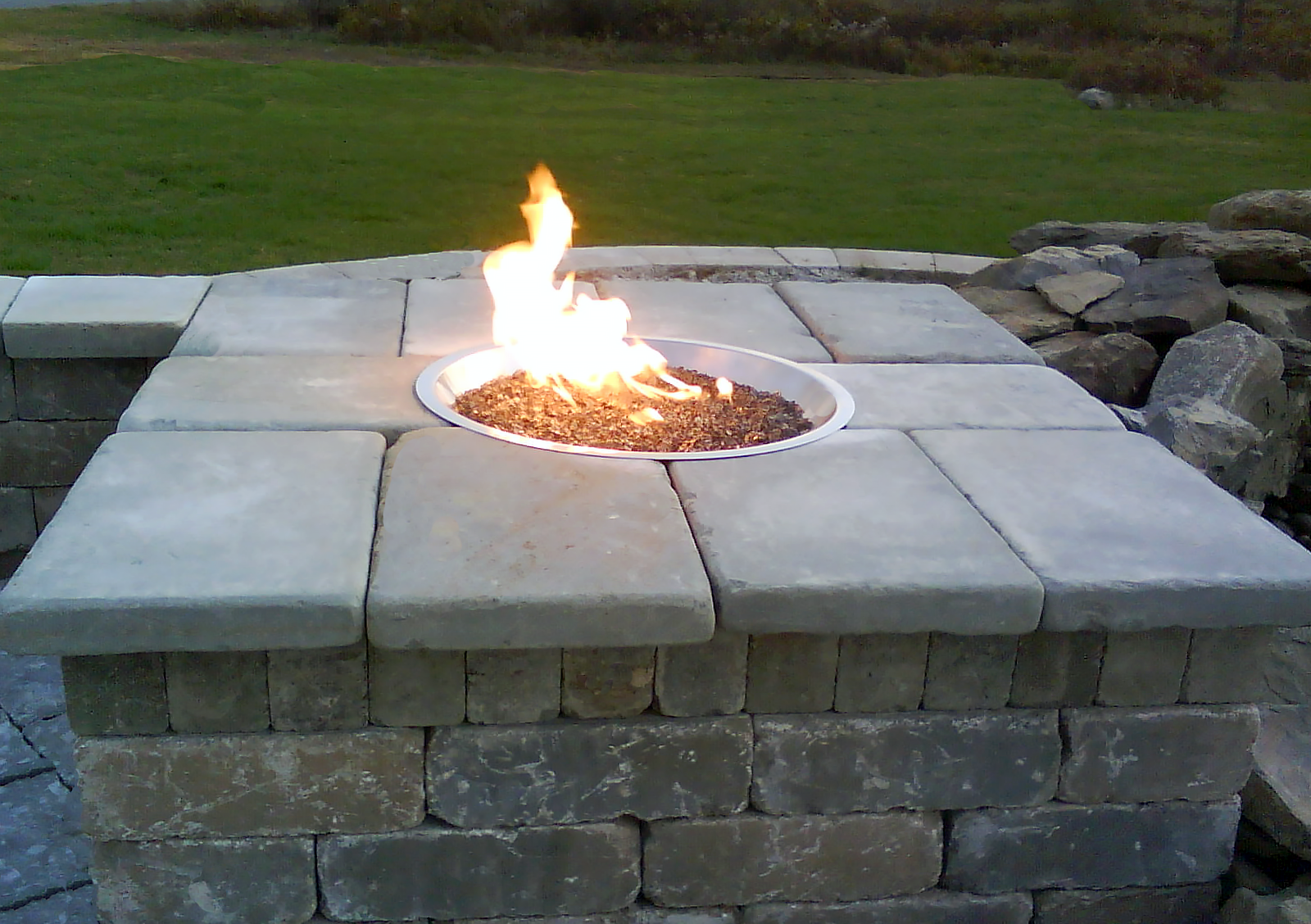 Pre-Cast Concrete Retaining Wall Stone capped with Tumbled Bluestone Coping. 