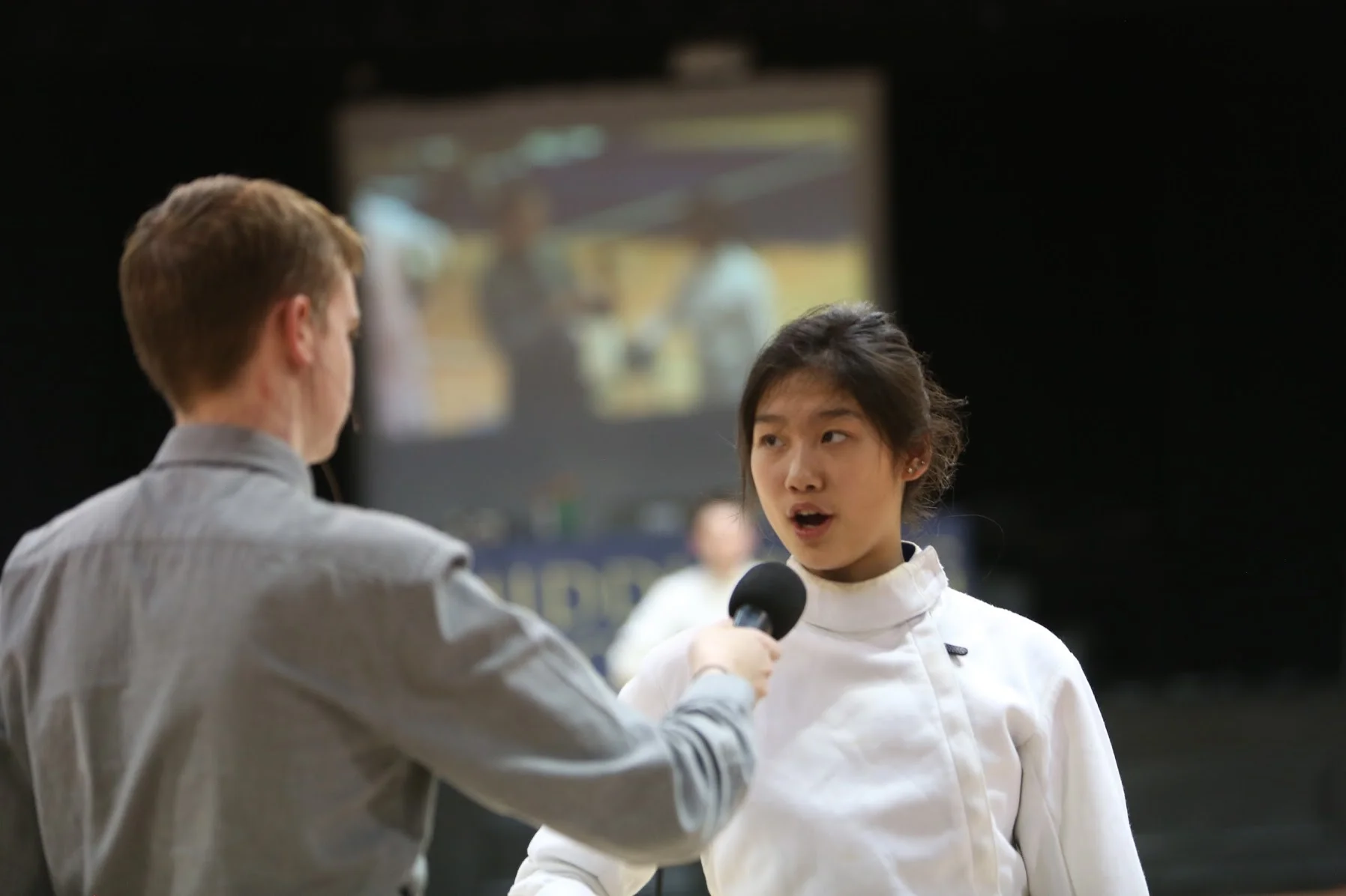 Dragon Video live-streams and replays on the big screen in The Dungeon. Here, a Dragon is interviewed for the fans.