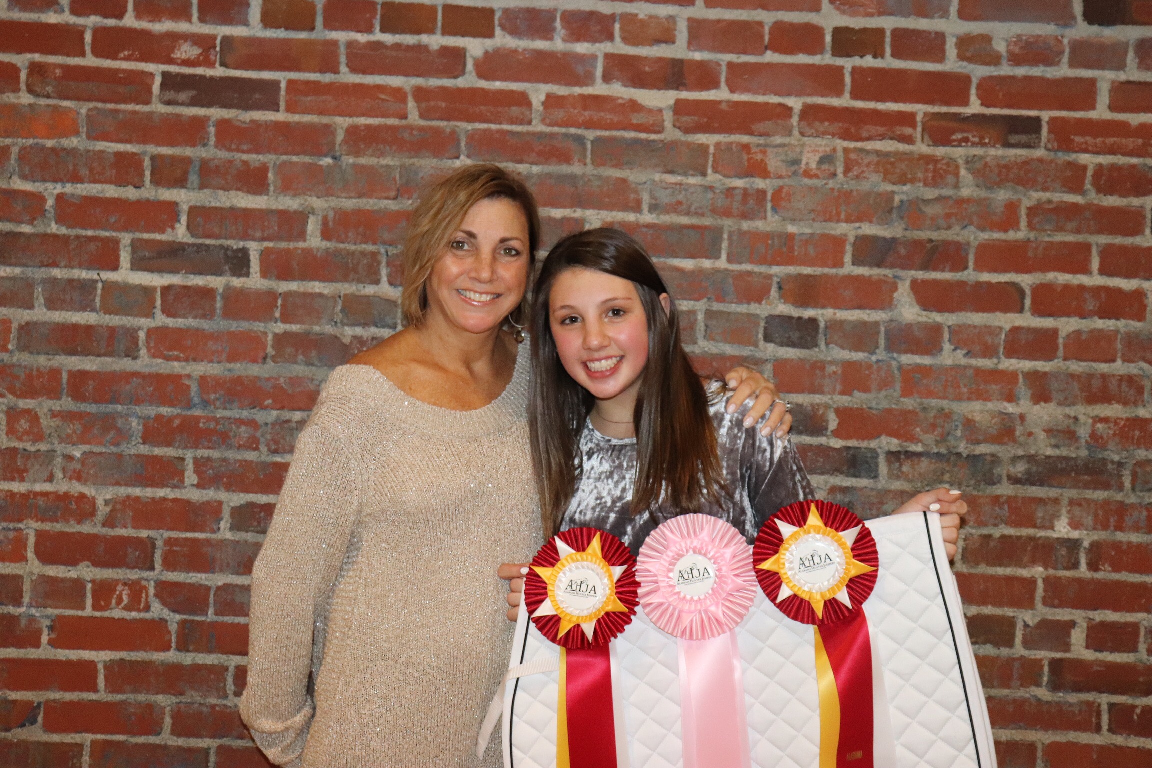 Emma Grace Early showing off her 2 Reserve Champion prizes and 5th place equitation ribbon with mom Lisa.