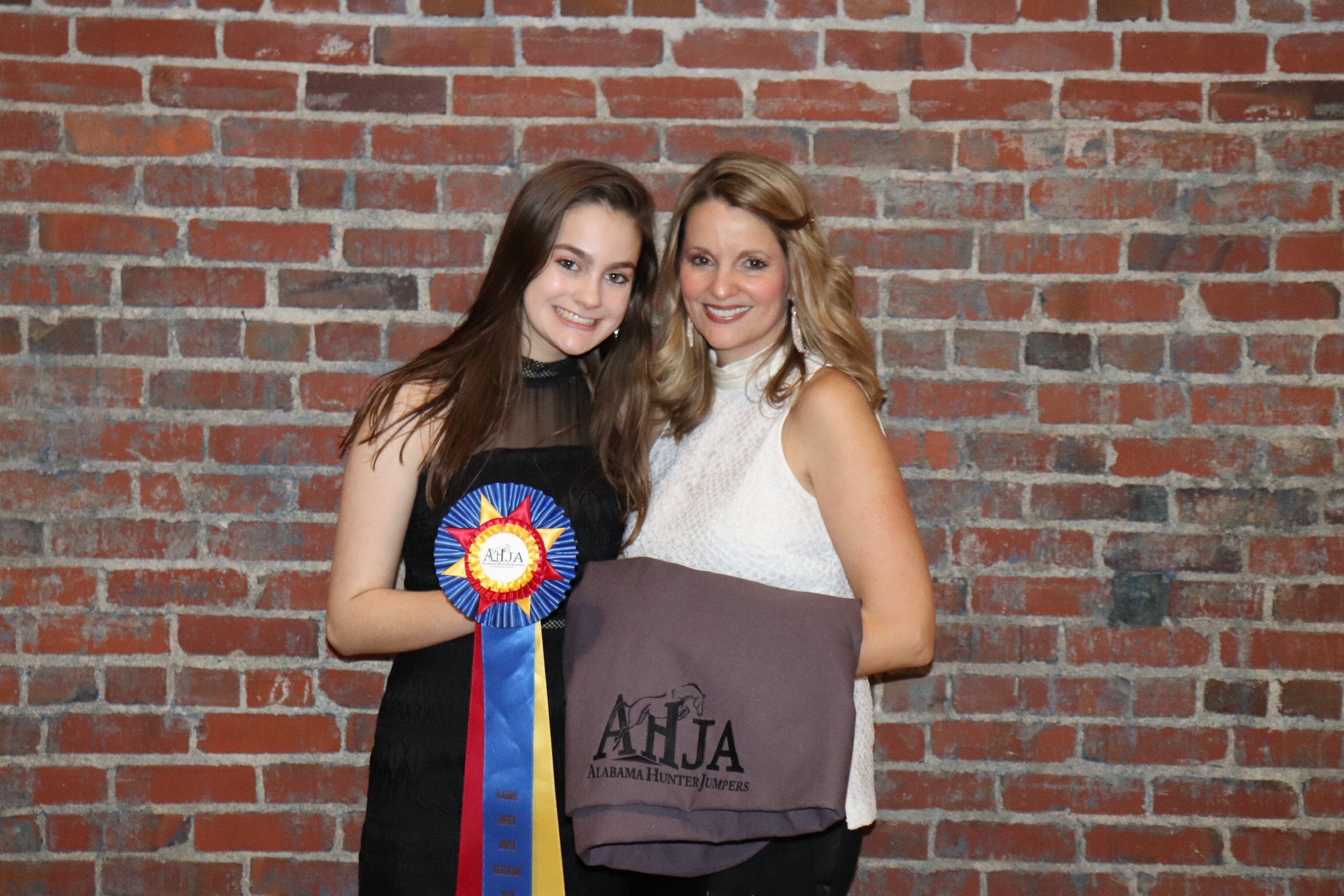 Campbell Swanner and mom Heather with Campbell’s USEF High Point ribbon for the Children’s Hunter division.