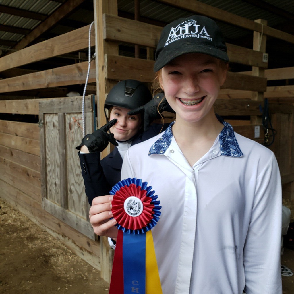 Lillian Reynolds celebrating her Champion ribbon with a little help from Kate Knowles.