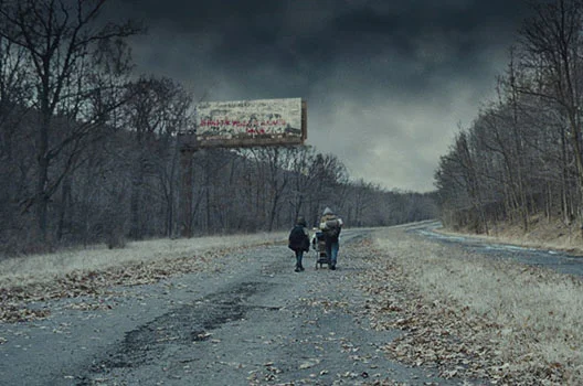 “The nights were long and dark and cold beyond anything they'd yet encountered. Cold to crack the stones. To take your life. He held the boy shivering against him and counted each frail breath in the blackness.” — Cormac McCarthy, The Road . ( Photo © 2009 Dimension Films.)