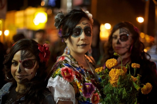 Women with calaveras makeup celebrating Día de Muertos in Mission District of San Francisco, California. Photo: Jared Zimmerman .