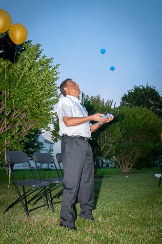 In order to exercise the brain, Sathya taught himself how to juggle. In this image he shows off his talent for friends and family.