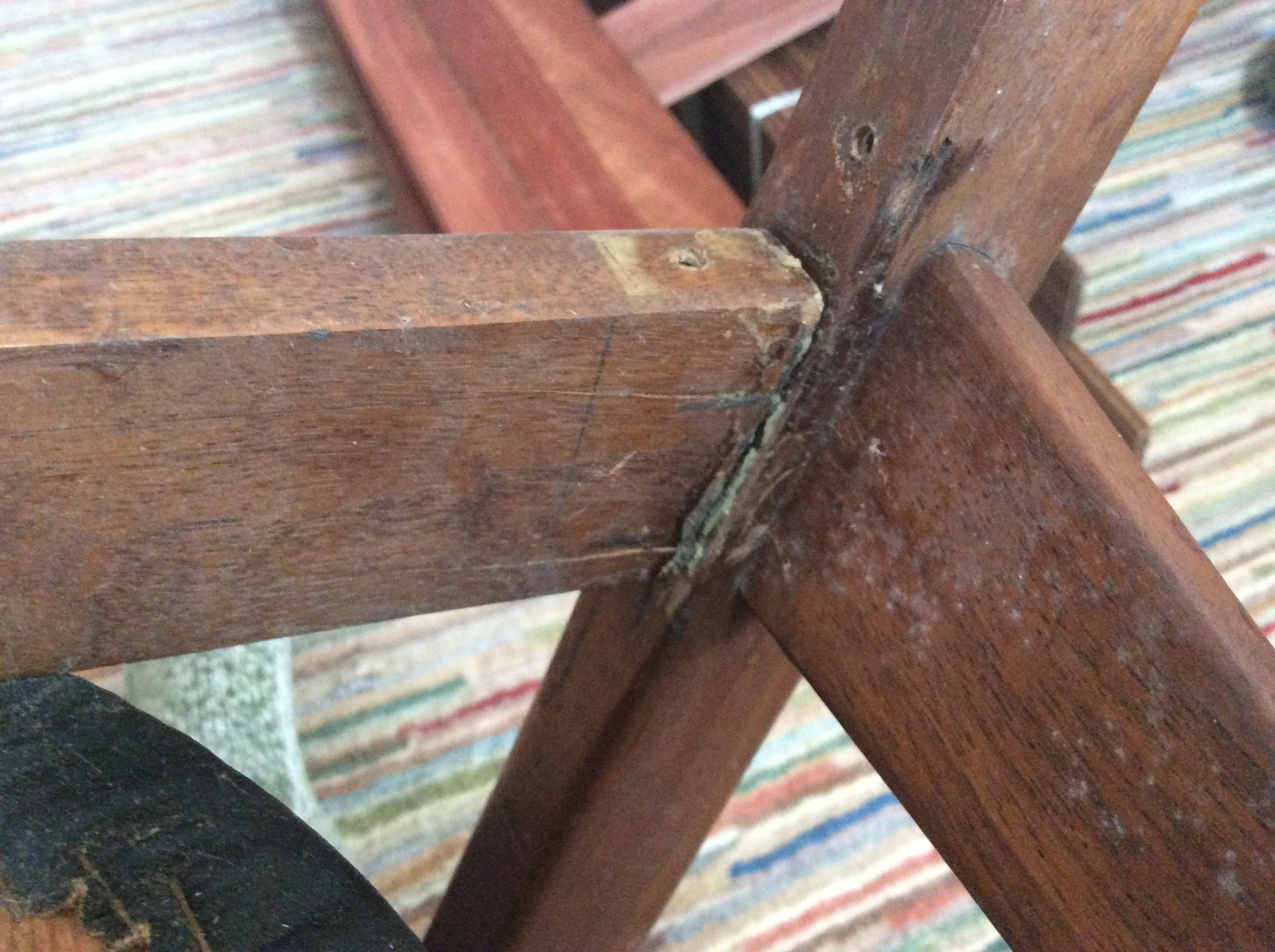 You can see how bad the previous repairs were in this picture. They used angle brackets (which were all broken in two), nasty glue, and hastily built-up dowels. Holes must have been drilled by hand, because everywhere they drilled a hole, they split the wood. Evidently they didn't use clamps. Anywhere.
