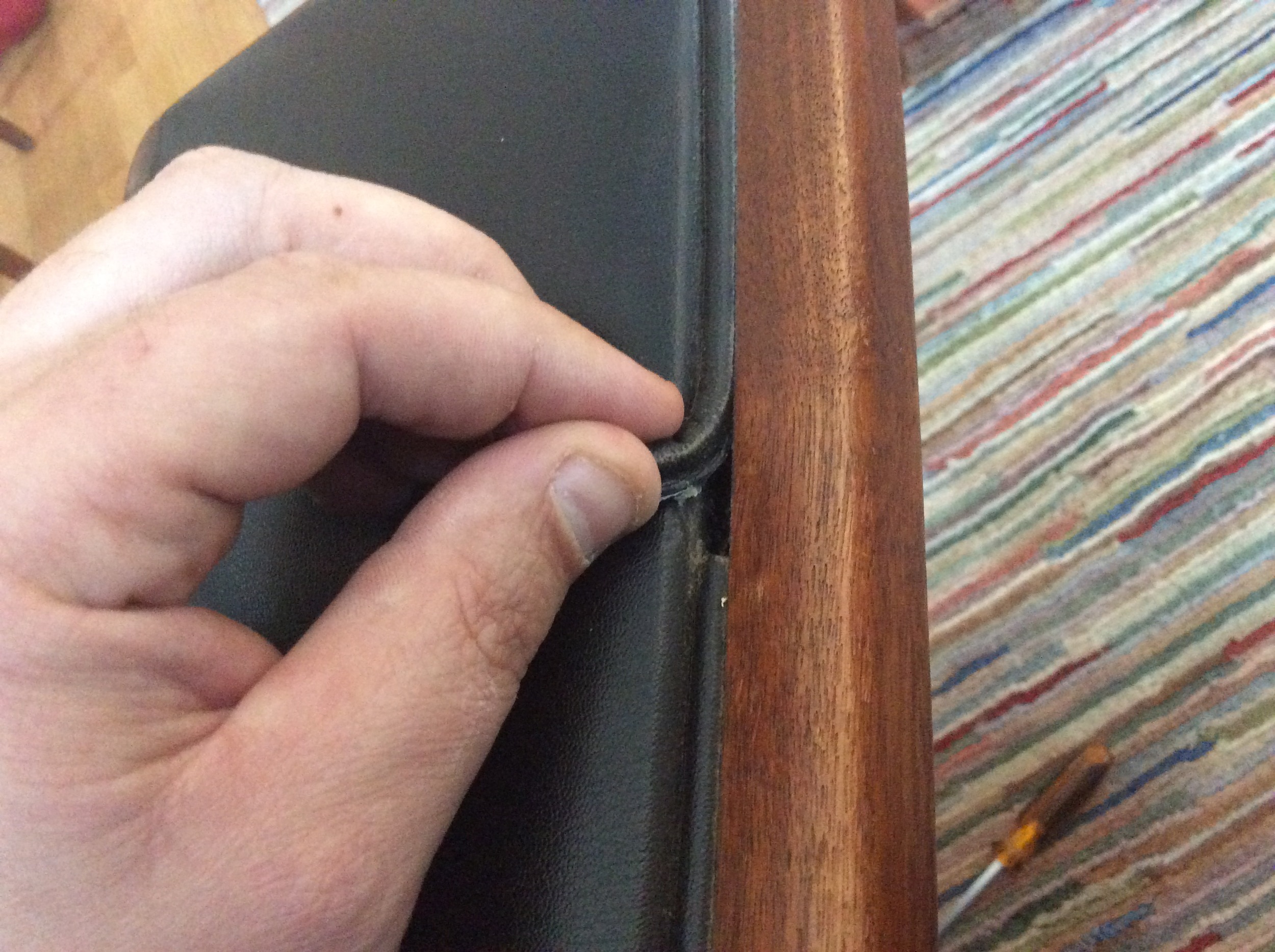 Ripping out the cording that was glued into the staple groove.