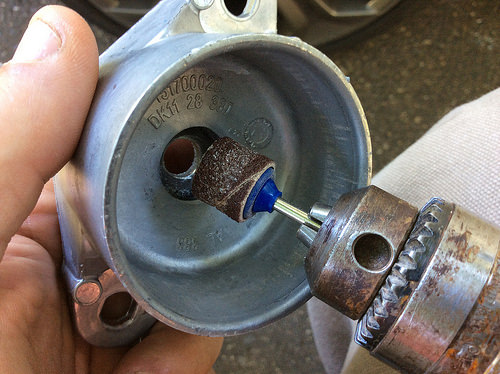 Modifying the rear shock tower mount to accept a shock that was made for a VW Beetle.