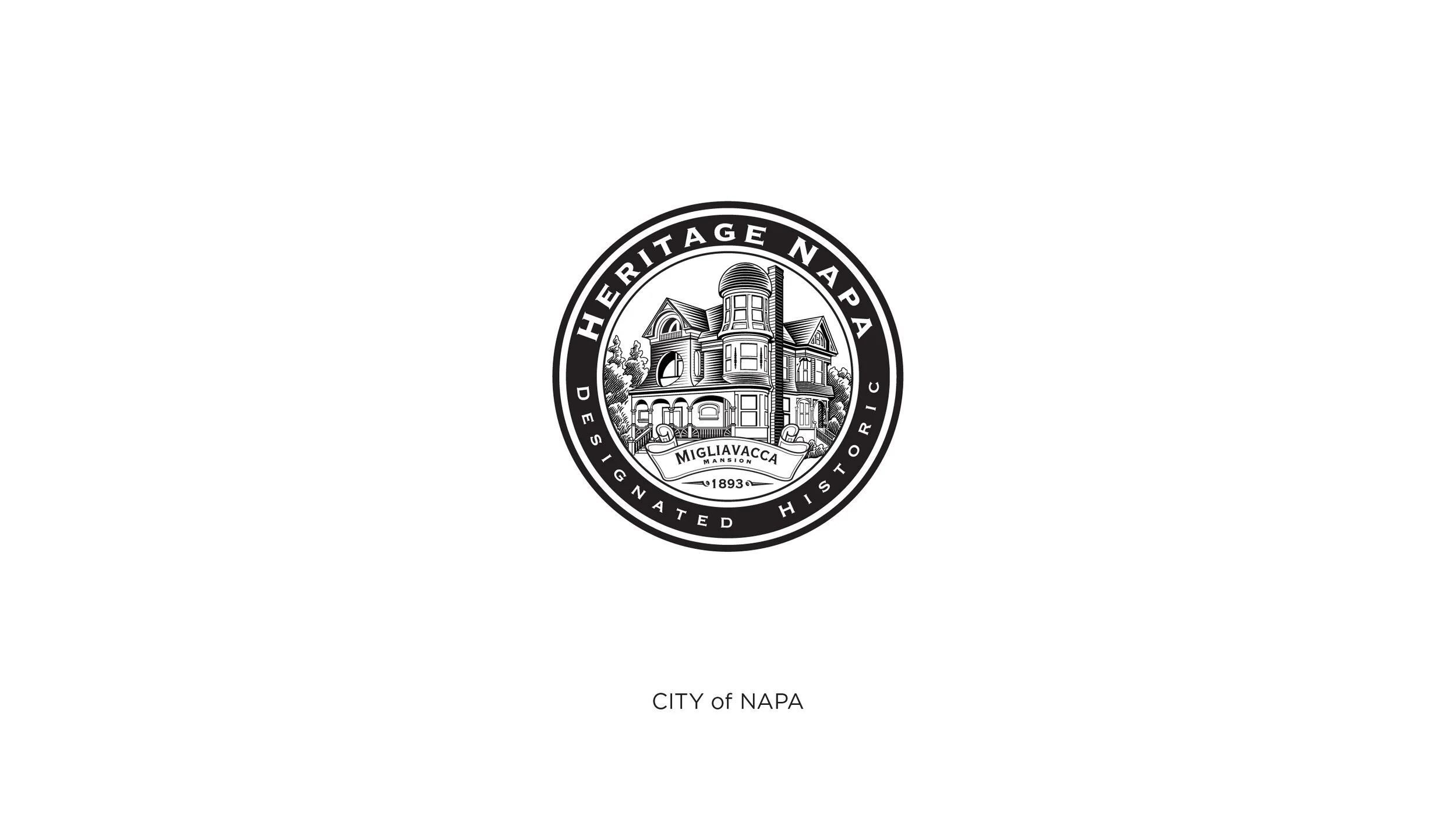 A black and white circular emblem featuring an illustration of a Victorian-style mansion with a tower, surrounded by trees. The outer ring of the emblem reads "HERITAGE NAPA" at the top with "MIGLIAVACCA MANSION 1893" on a banner beneath the house.