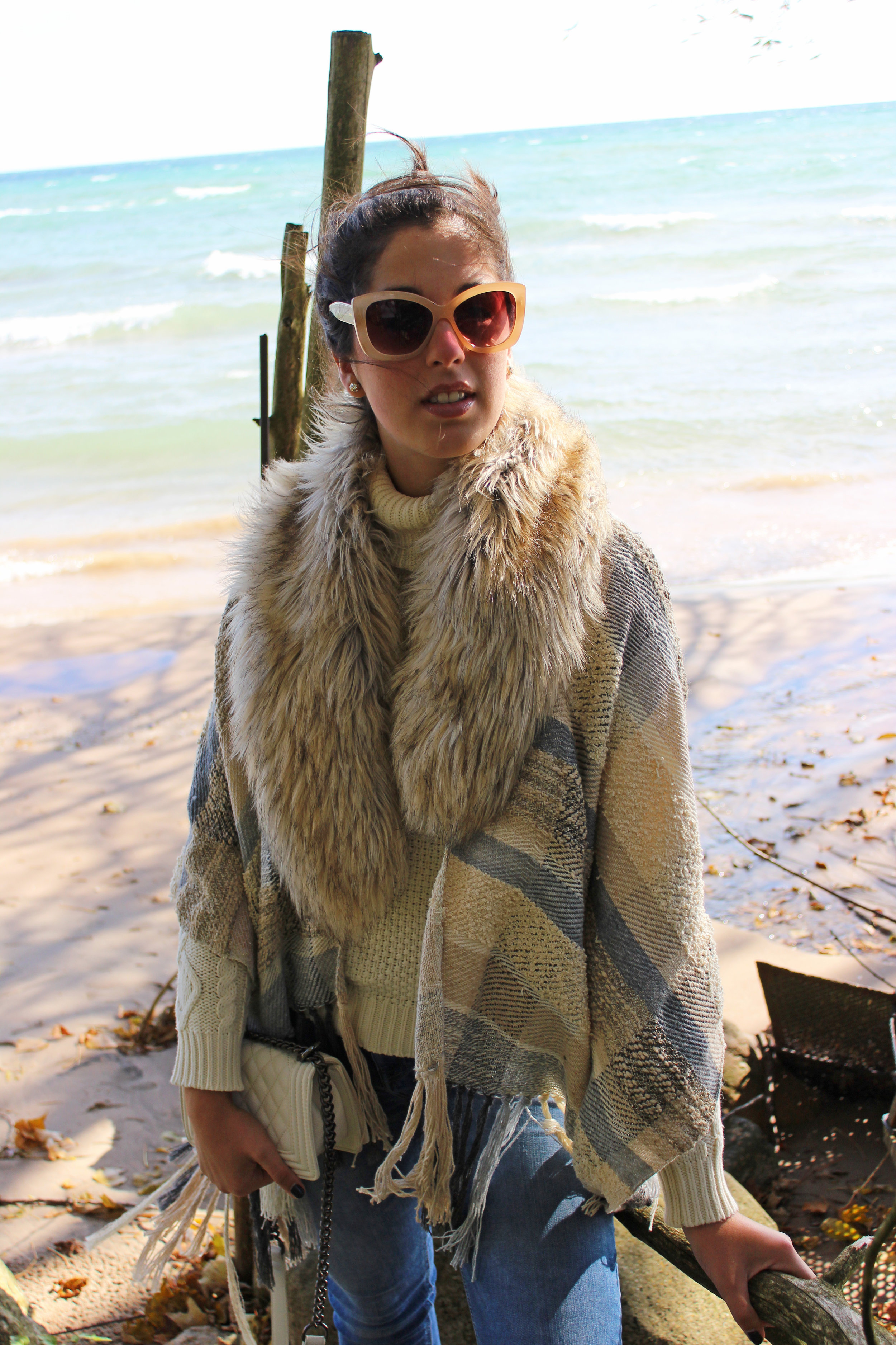 Madalyn Manzeck photographed by Cassie Sterwald in her backyard on Lake Michigan in 2016. Poncho Madalyn Joy Designs // Turtleneck Sweater (similar) Ralph Lauren // Faux Fur Stole (similar) Anthropologie // Jeans (similar) Zara // Heels (similar) Madden Girl // Earrings Kate Spade // Shoulder Bag Forever 21 // Nail Colour Taken By Storm Atlantic Pacific x Formula X
