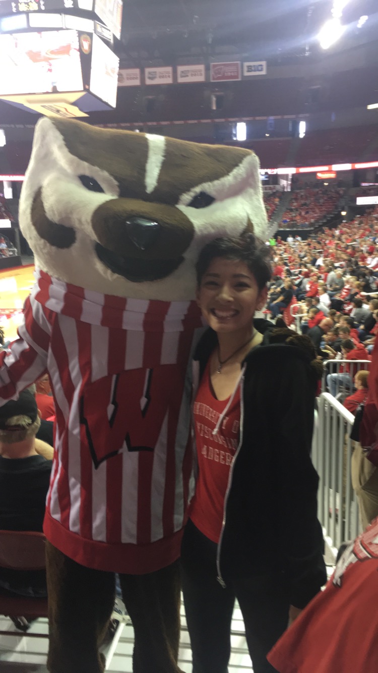 Vanali posing with Bucky Badger at a UW-Madison Badger basketball game. 
