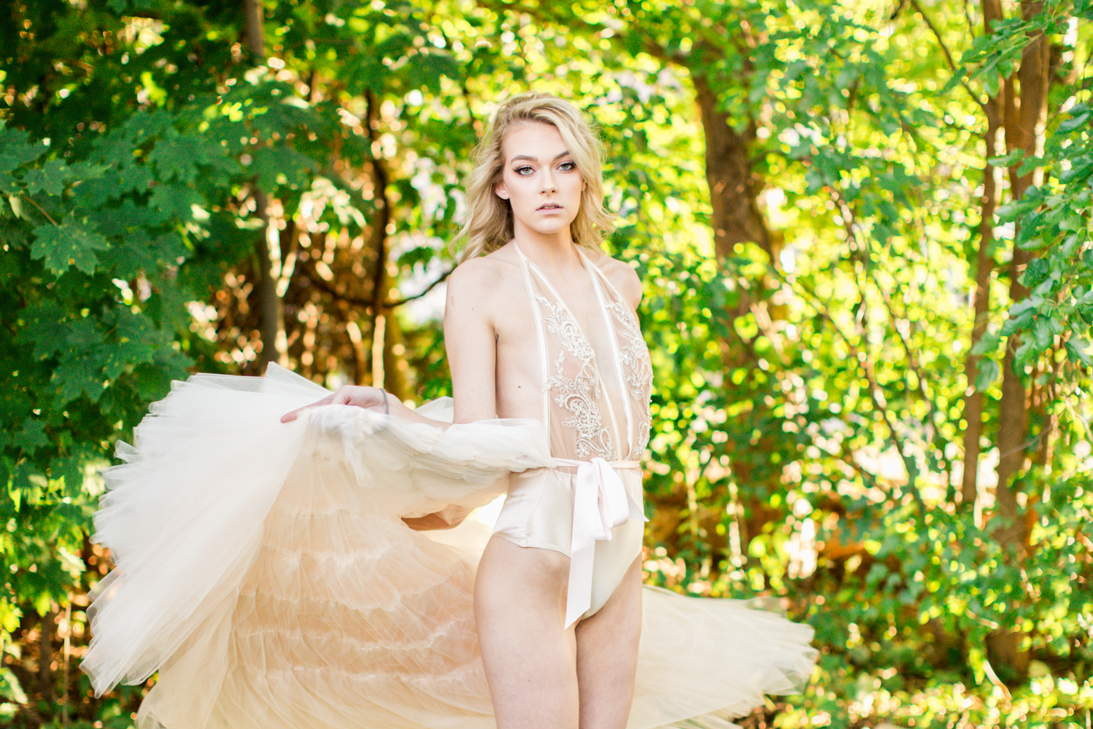 Nicole Petrie twirling in her champagne tulle skirt and hand embellished satin bodysuit. 