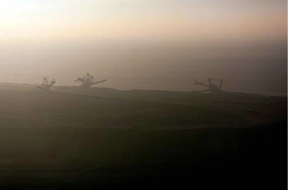 Machines Working at Sunset in Brown Coal Mine