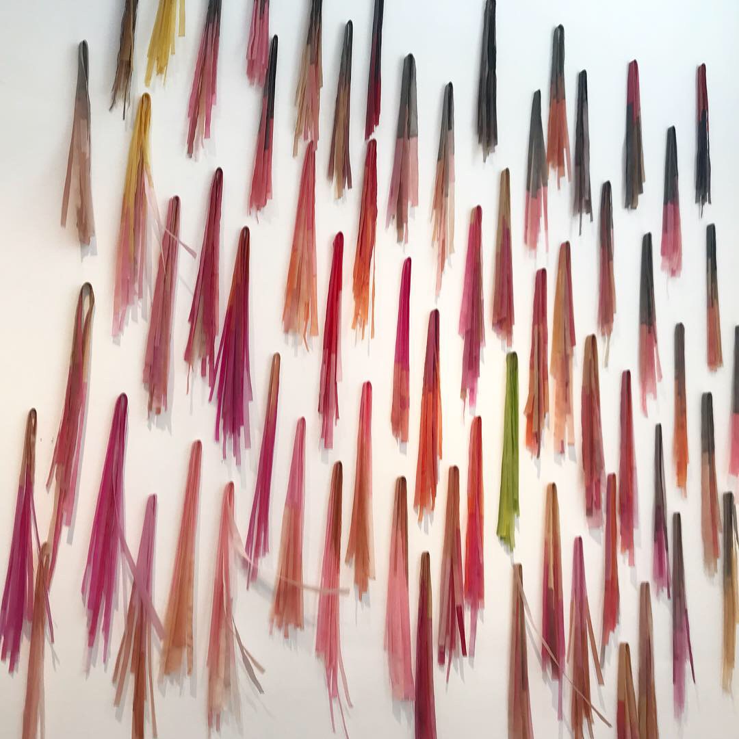  Harvesting Color Wall Installation, 2019 Mulberry paper, watercolor, ink, wax 12’ x 15’  Harvesting color derives from the springtime ritual of picking fresh flowers and hanging them on a wall to dry. The strips of color evoke the fleeting visual bo